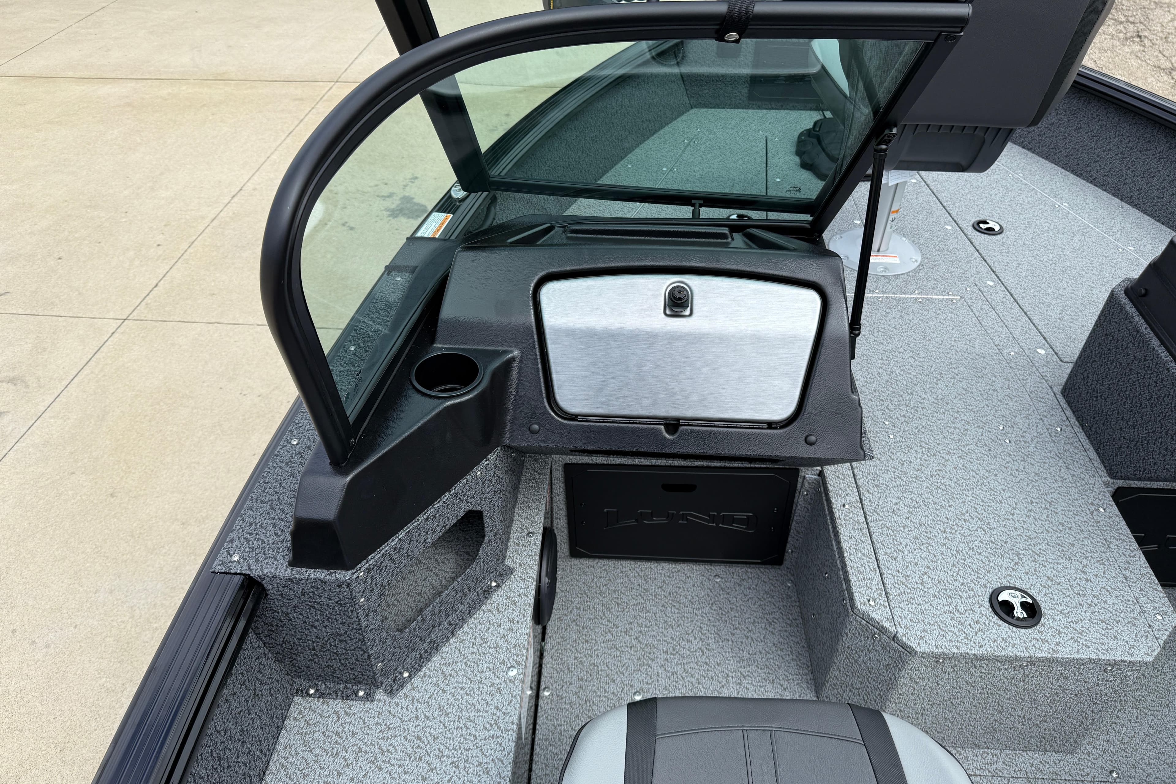 2026 Lund 1800 Explorer Sport boat interior with windshield and storage compartments.