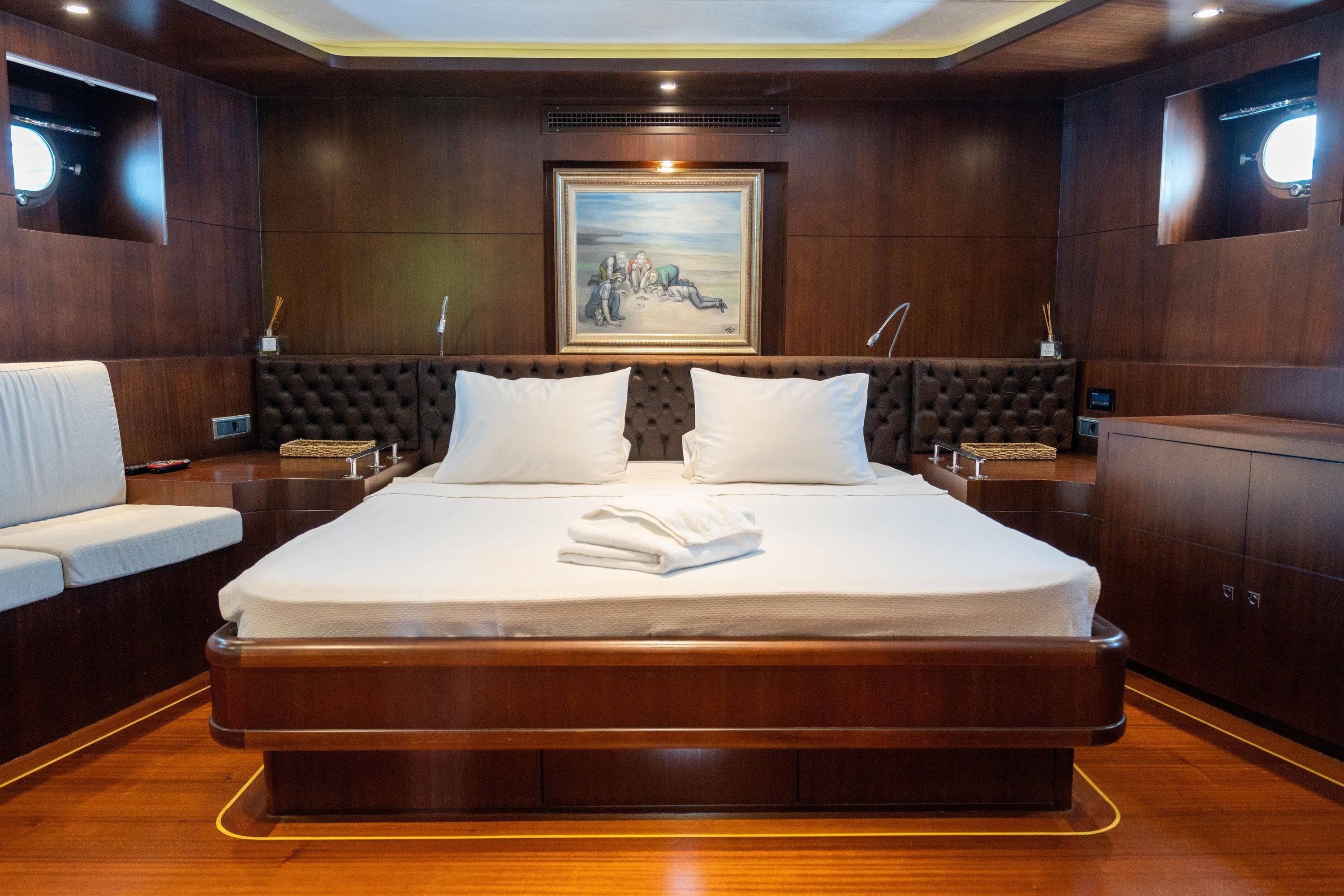 Luxurious bedroom interior on 2009 Ada Yacht Ketch, featuring elegant wood paneling and plush bedding.