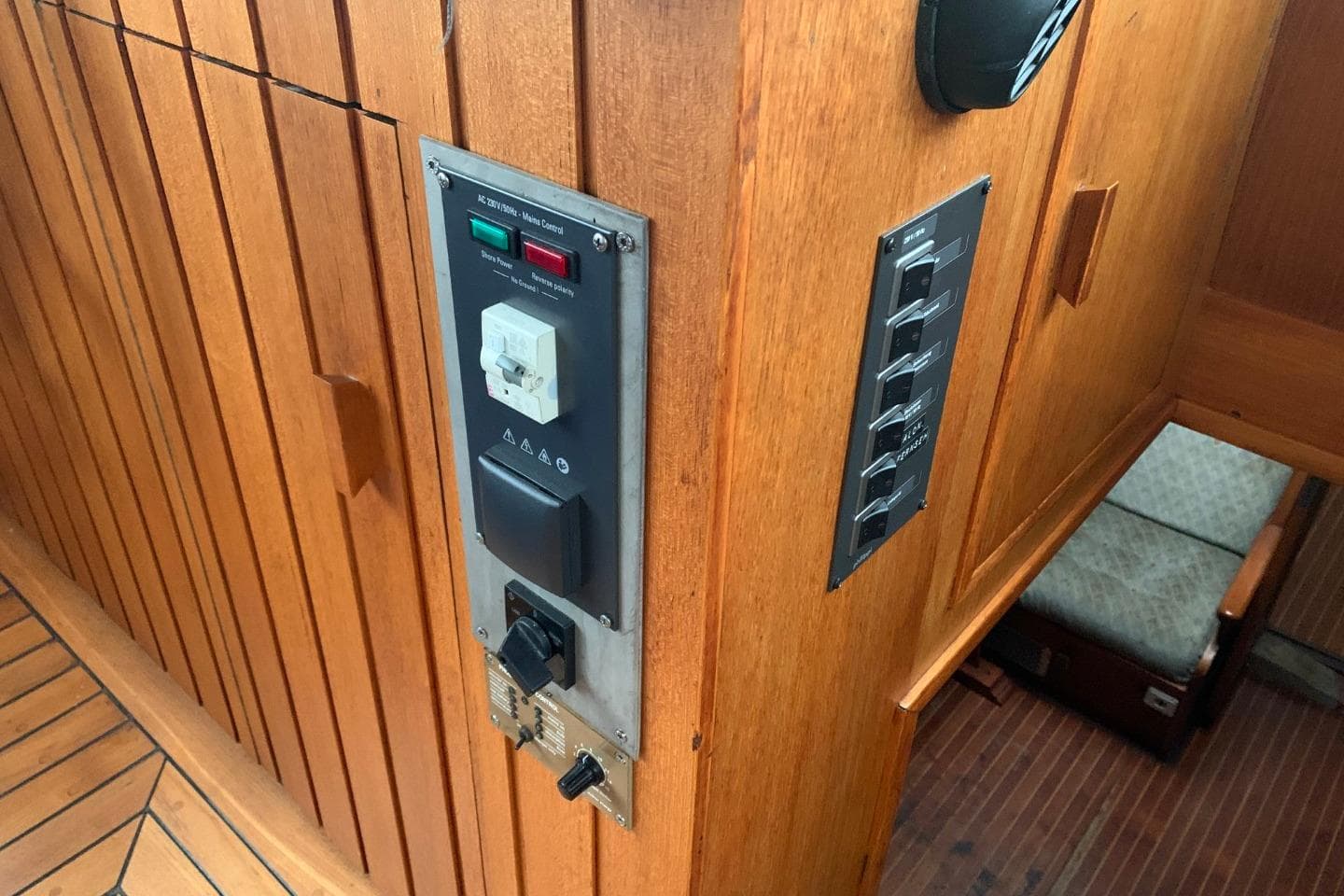 1979 Bueltjer Motorsailer interior with wooden paneling and control switches.