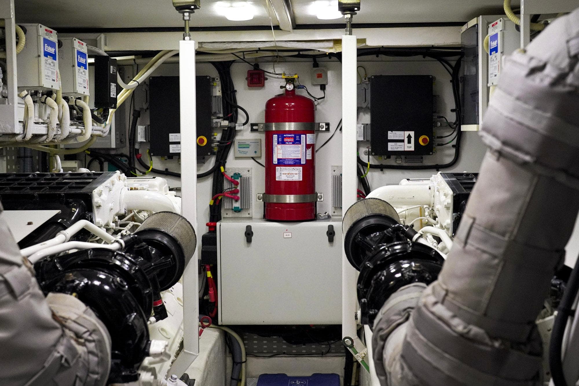 Engine room of 2007 Princess 23M yacht with fire extinguisher and machinery.