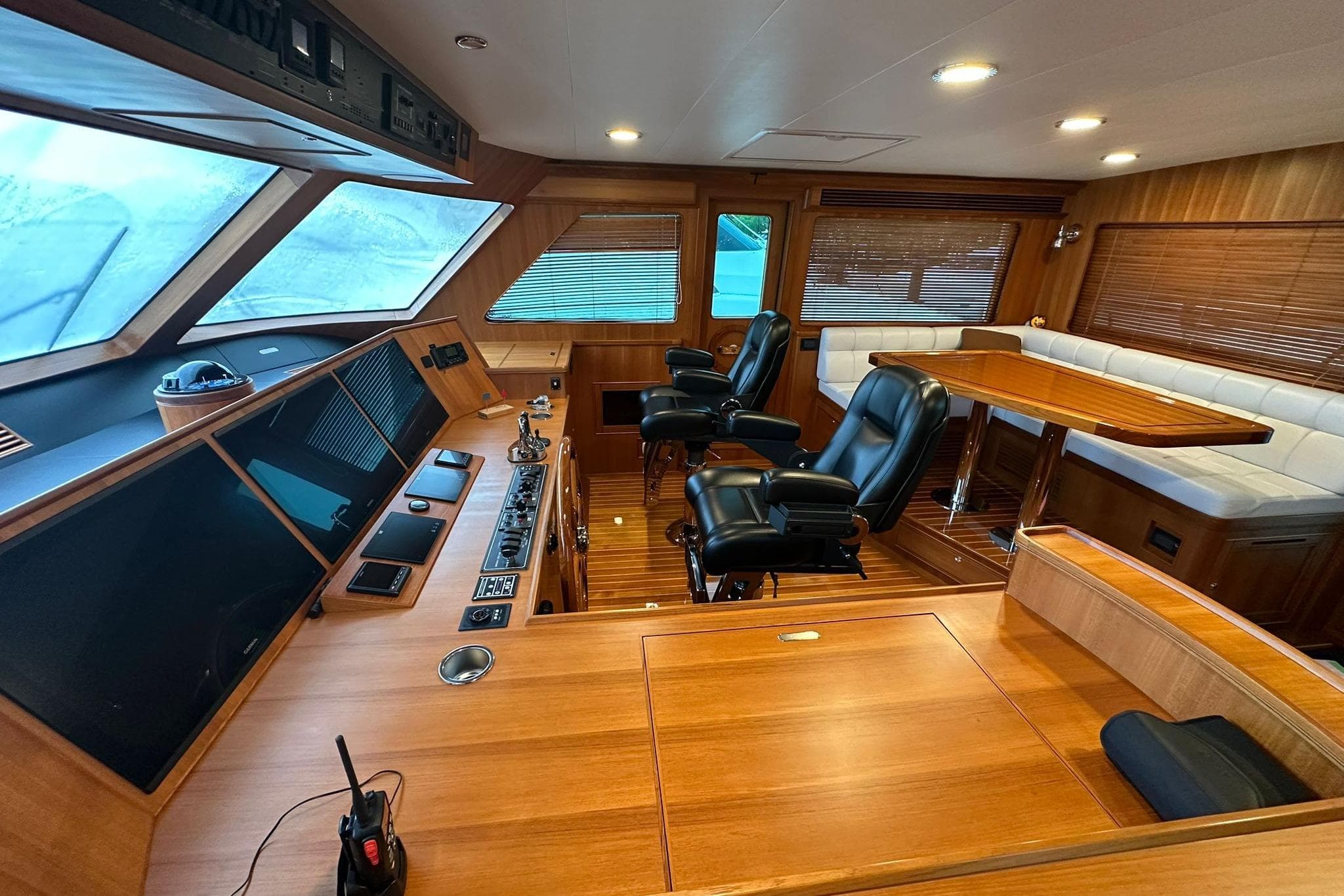 Luxurious interior of 2023 Marlow Explorer 66E-CB yacht with leather seating and wooden finishes.