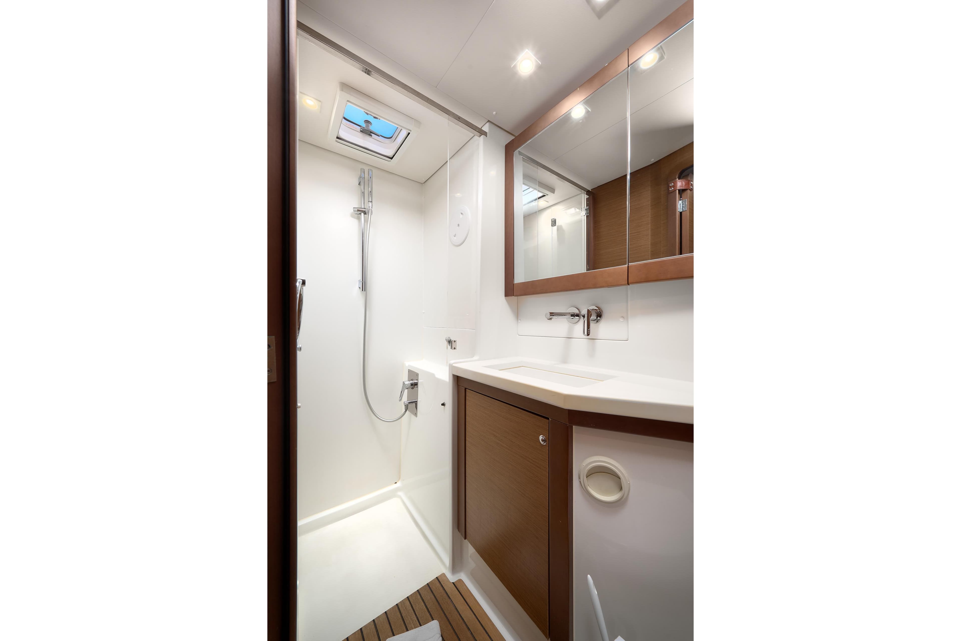 Modern bathroom interior on 2018 Lagoon 450 yacht, featuring shower and vanity.