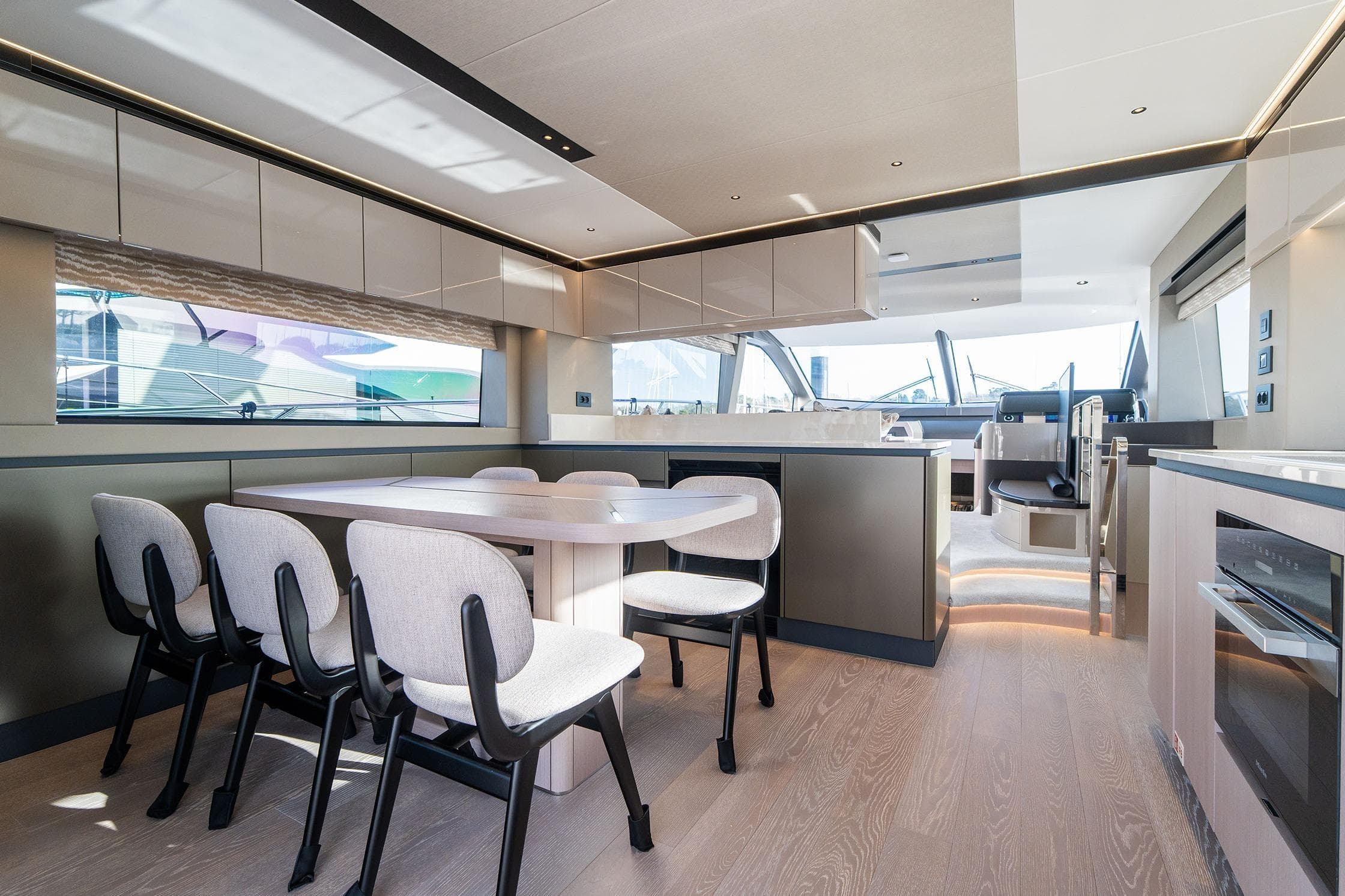 Luxurious interior of 2026 Sunseeker Manhattan 68 yacht with modern dining area.