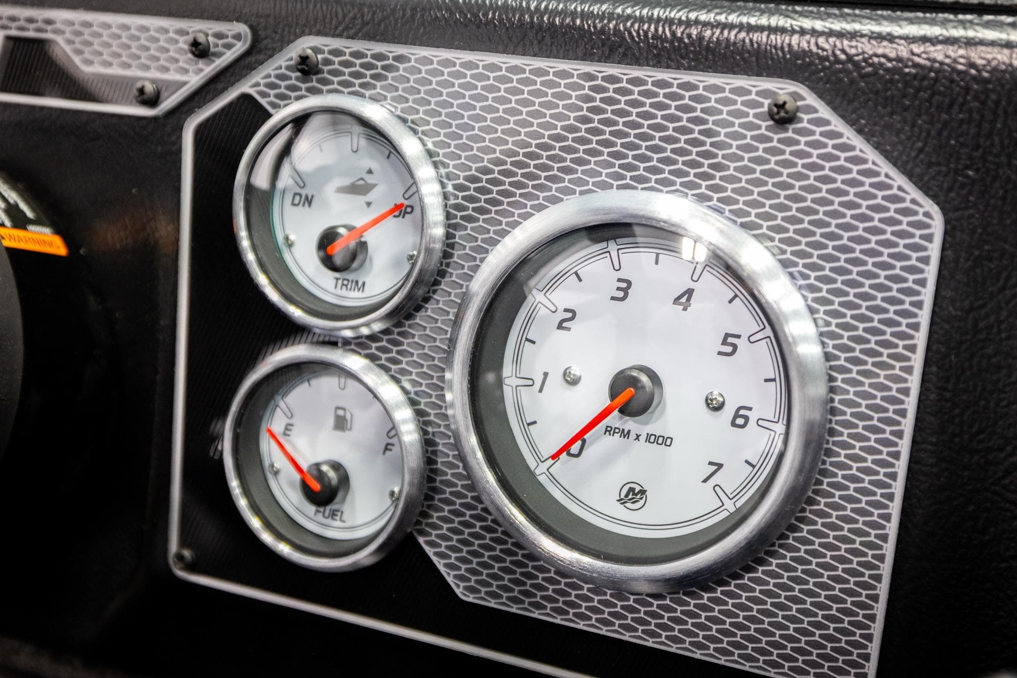 Dashboard gauges of 2026 Lund 2075 Impact XS boat, featuring RPM, trim, and fuel indicators.