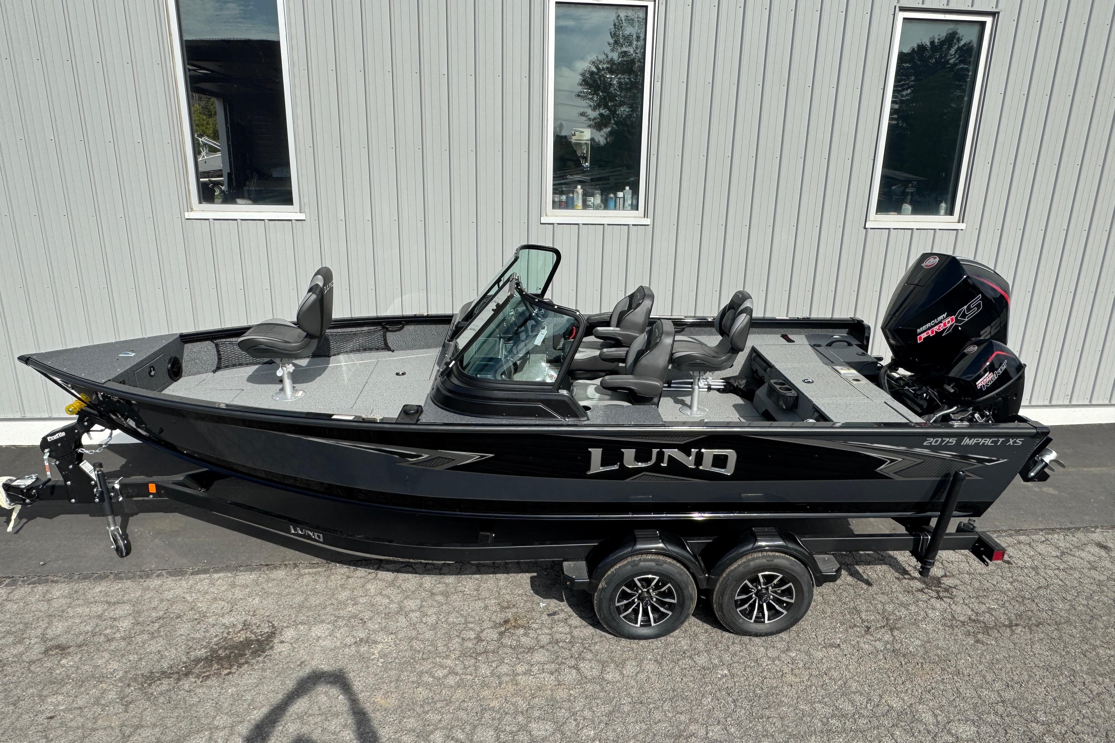 2026 Lund 2075 Impact XS fishing boat, black exterior, parked on a trailer.
