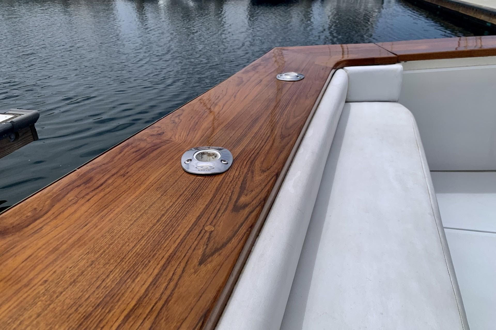 1984 Egg Harbor 48' Flybridge with polished wood and white seating by the water.