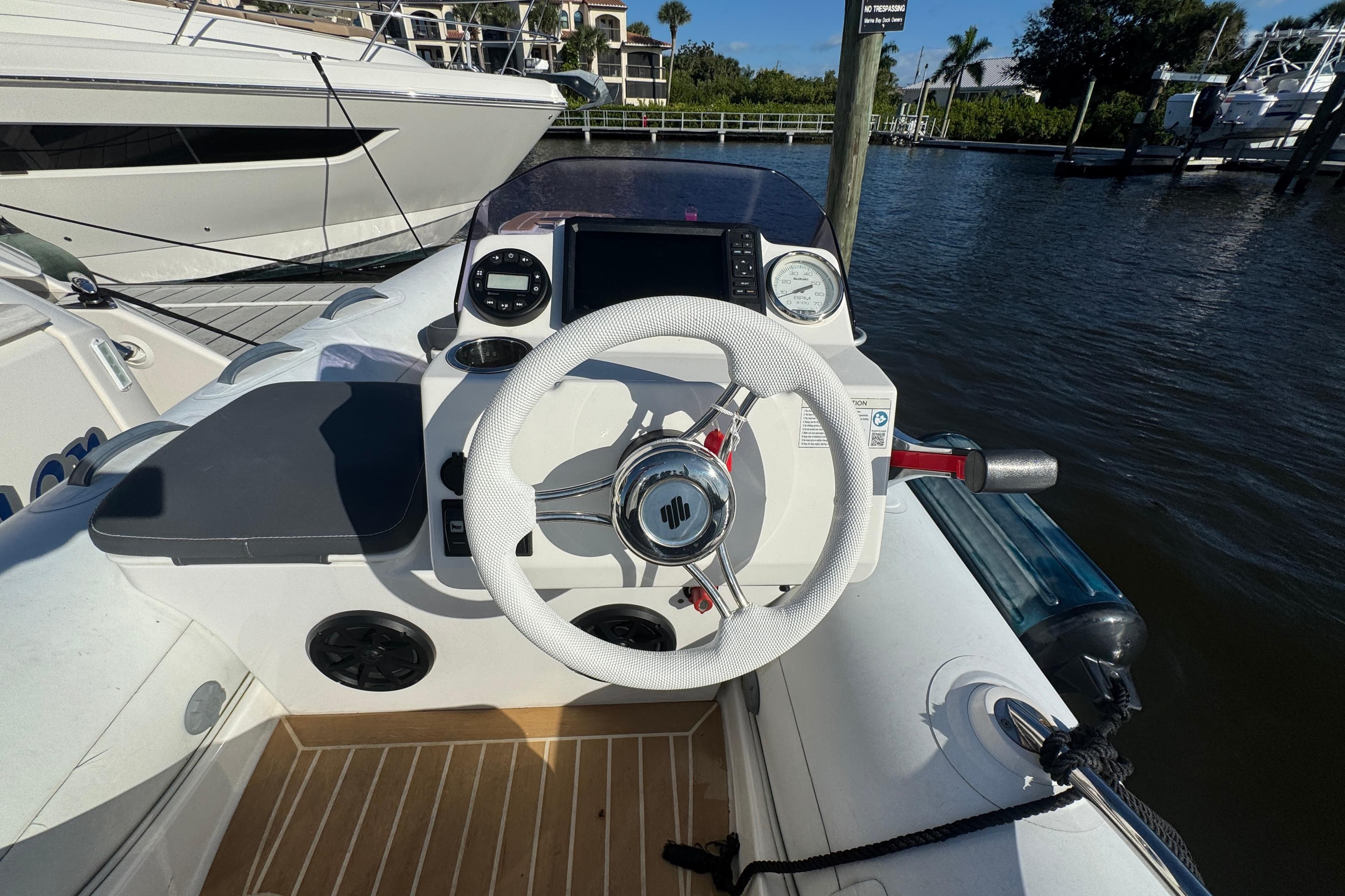 Helm of 2016 Tiara Yachts C44 Coupe with white steering wheel and navigation instruments.
