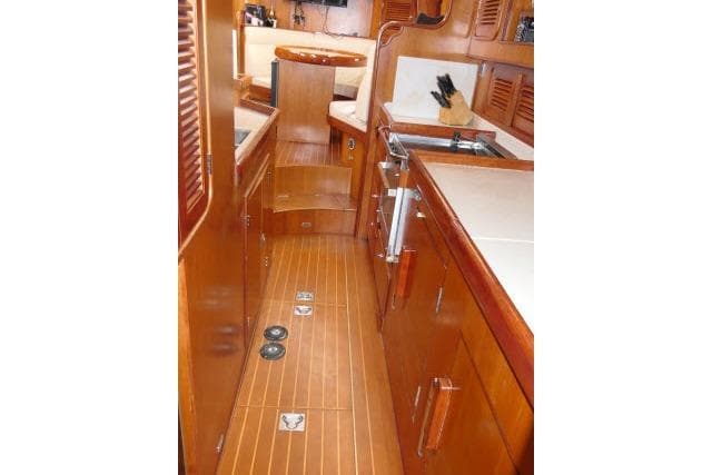 Interior of 2006 Tayana 58 Deck Salon yacht with wooden cabinetry and flooring.