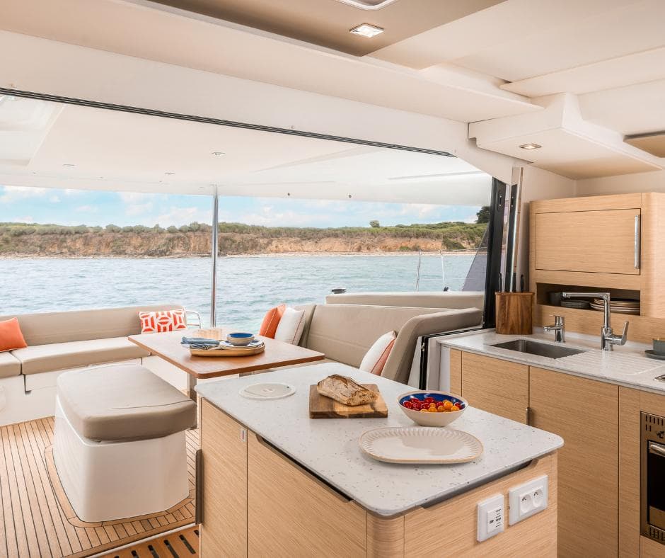 Luxurious interior of 2025 Fountaine Pajot NEW 41 catamaran with modern kitchen and seating area.