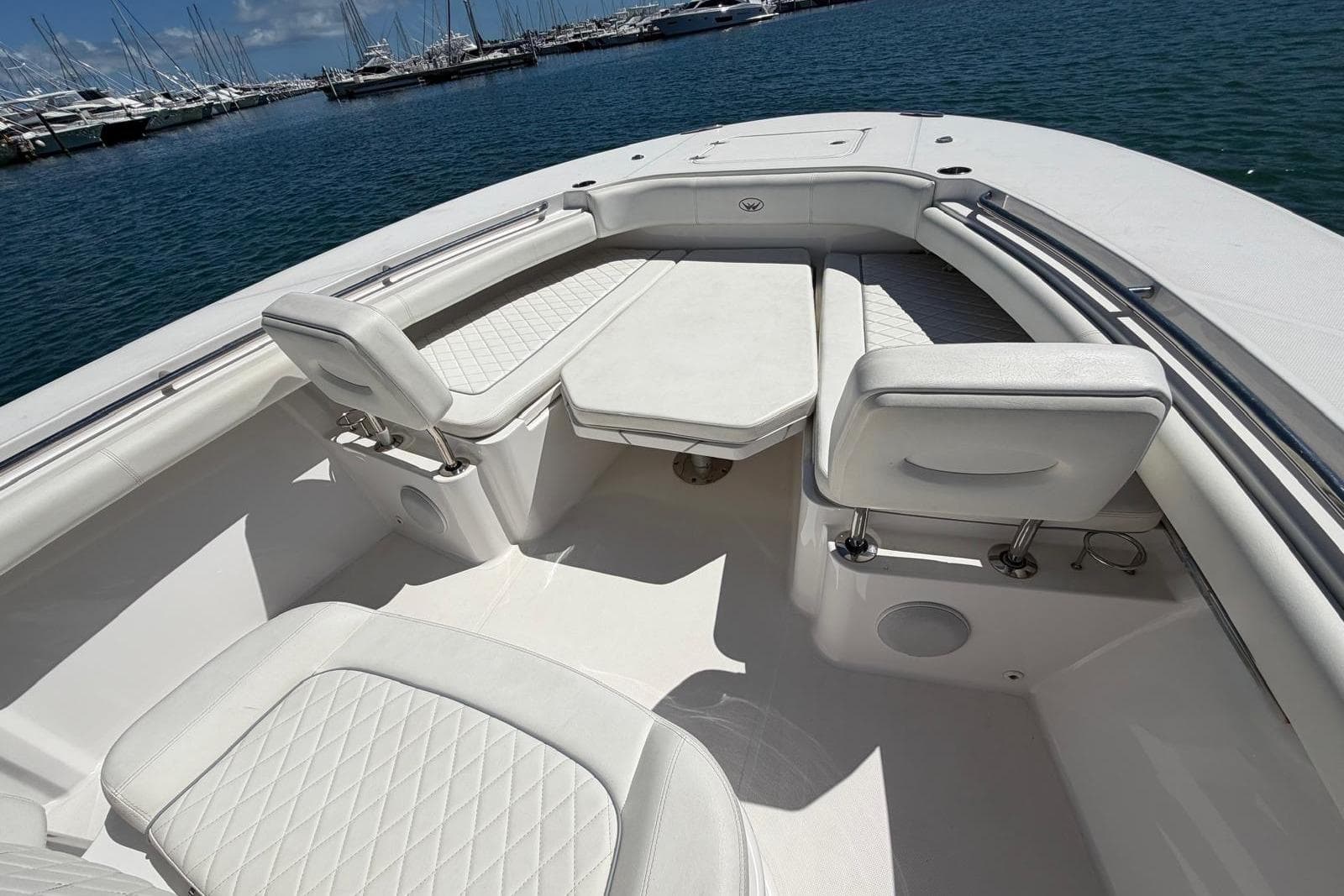 2021 Southport 30 FE boat interior with white seating and table, docked at marina.