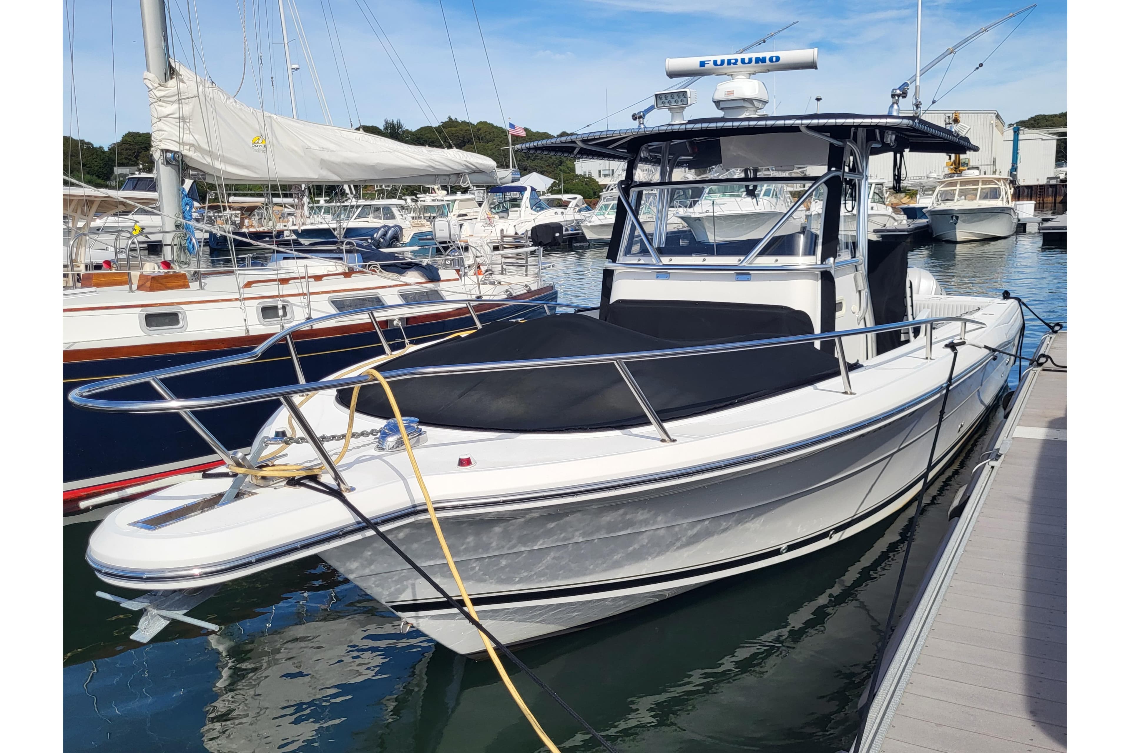 2005 Stamas 310 Tarpon boat docked in a marina, featuring sleek design and modern equipment.