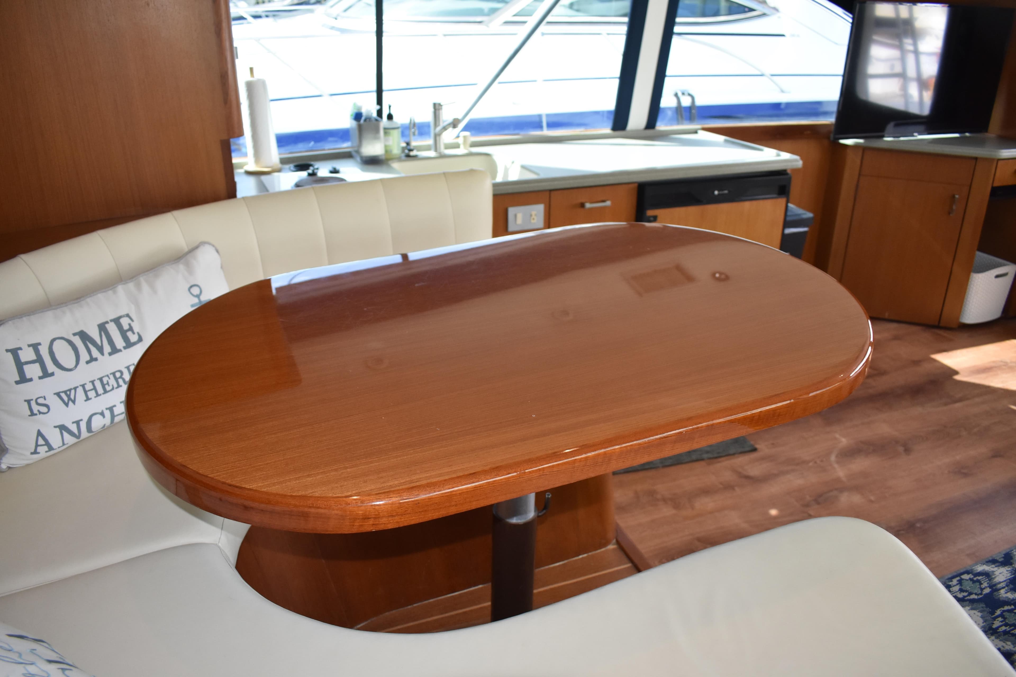 Interior of 1998 Ocean Yachts 40 Super Sport with wooden table and white seating.