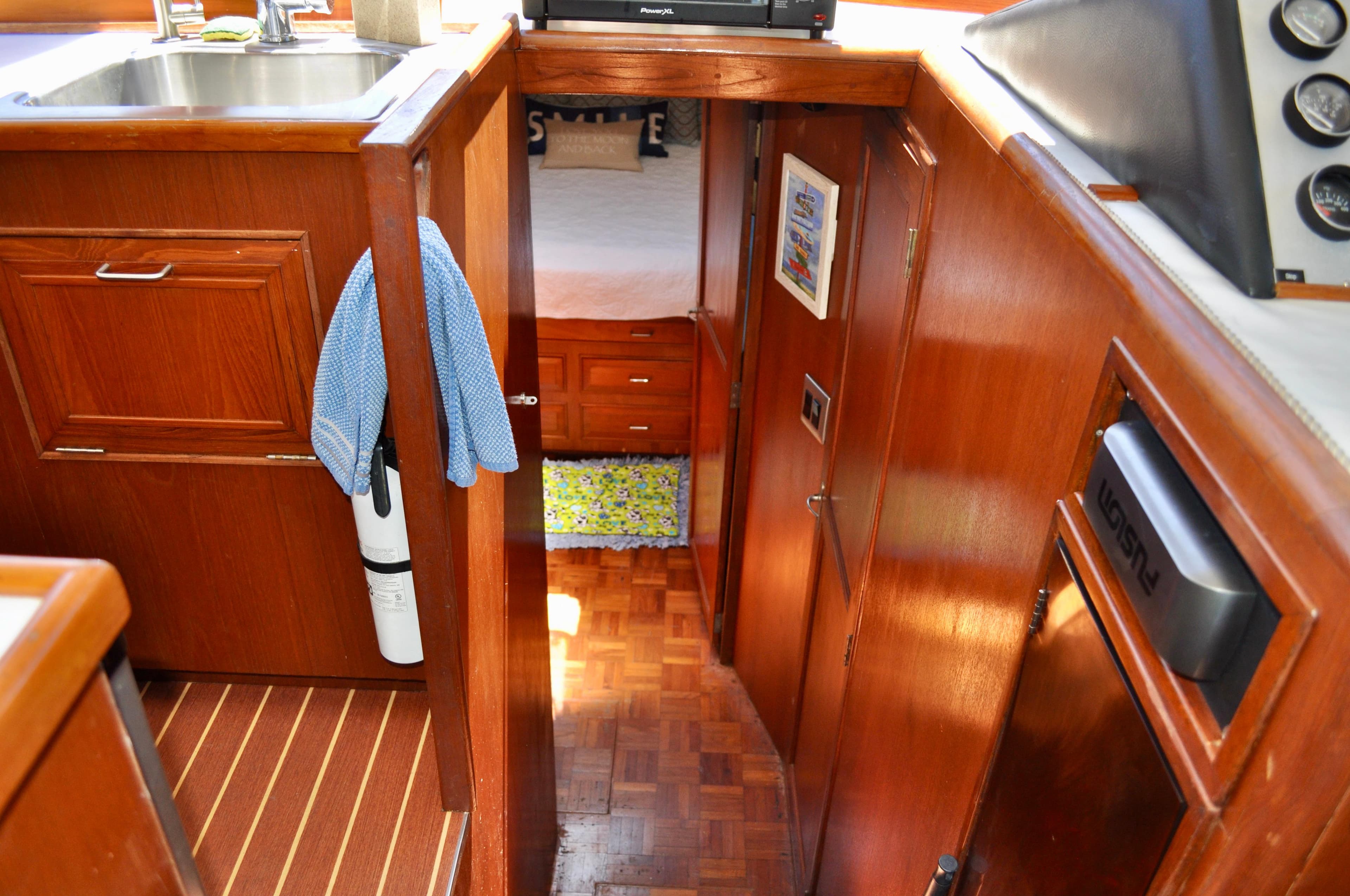 Interior of 1990 Ocean Alexander 42 Sedan yacht with wooden cabinetry and cozy cabin.