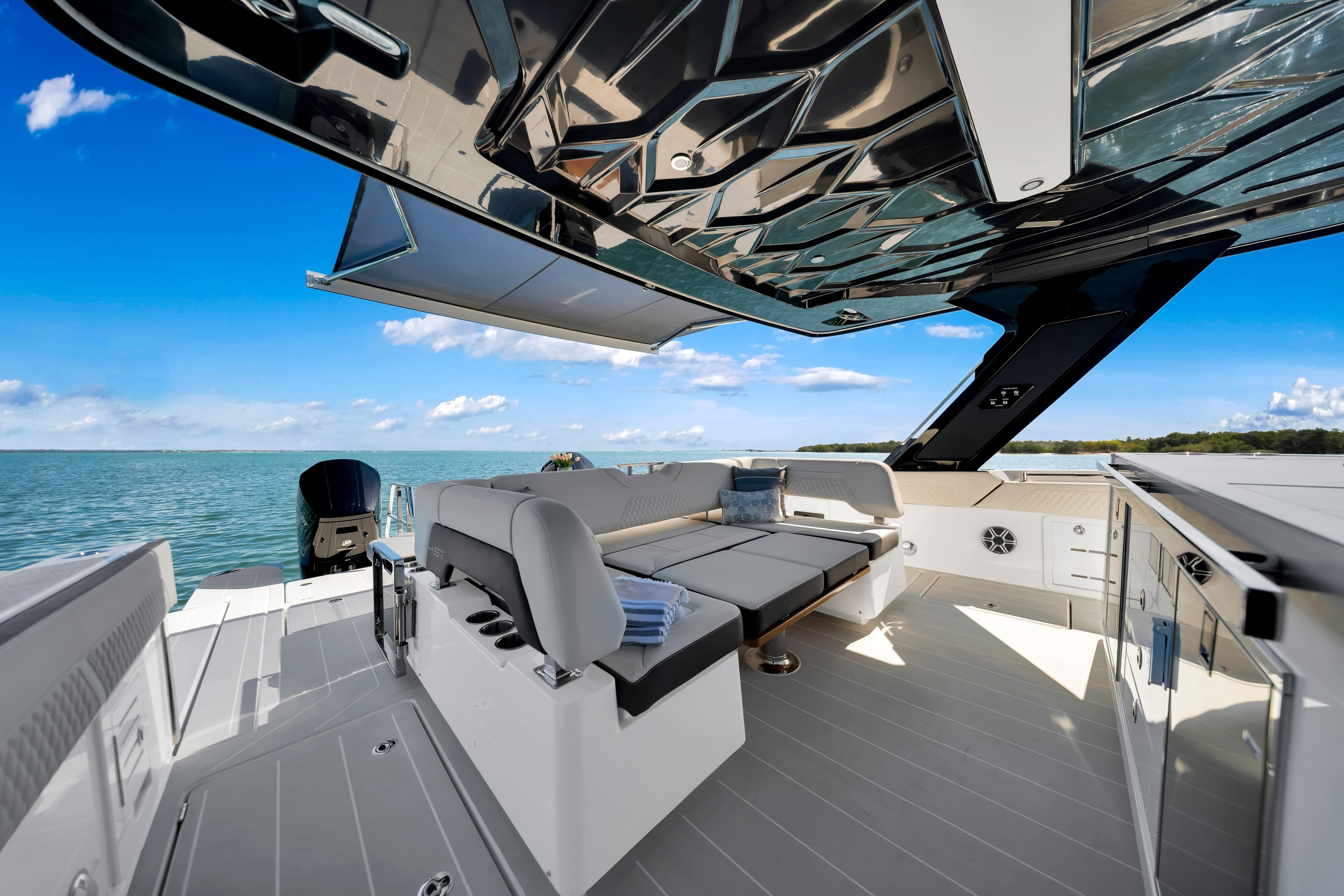 Luxurious 2026 Aquila 45 Sport yacht interior with sleek seating and stunning ocean view.