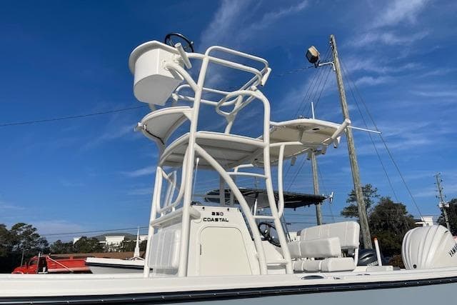 Parker 230 Coastal Elite 2026 with elevated helm against blue sky.