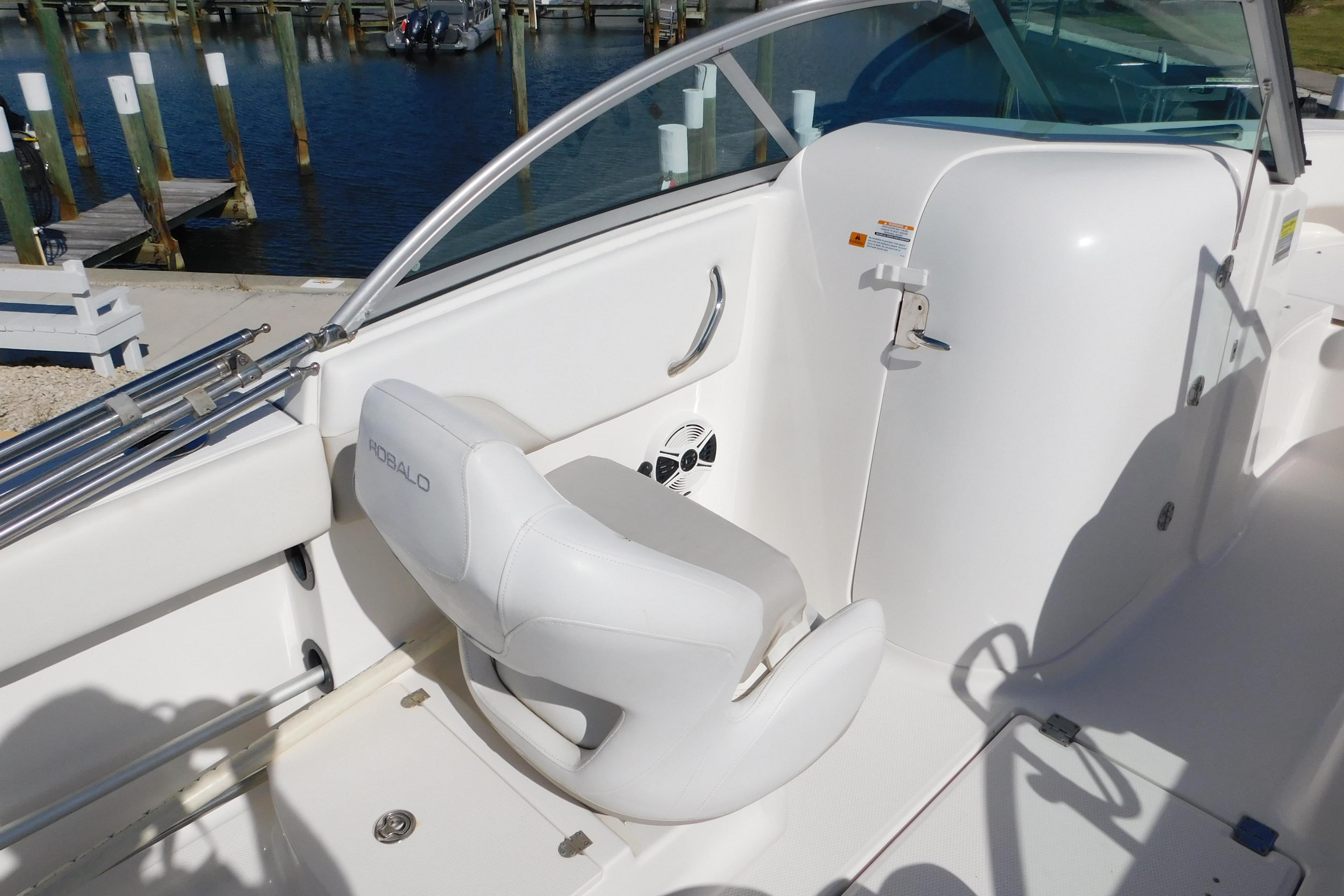 2014 Robalo R207 Dual Console boat interior with white seating and dock view.