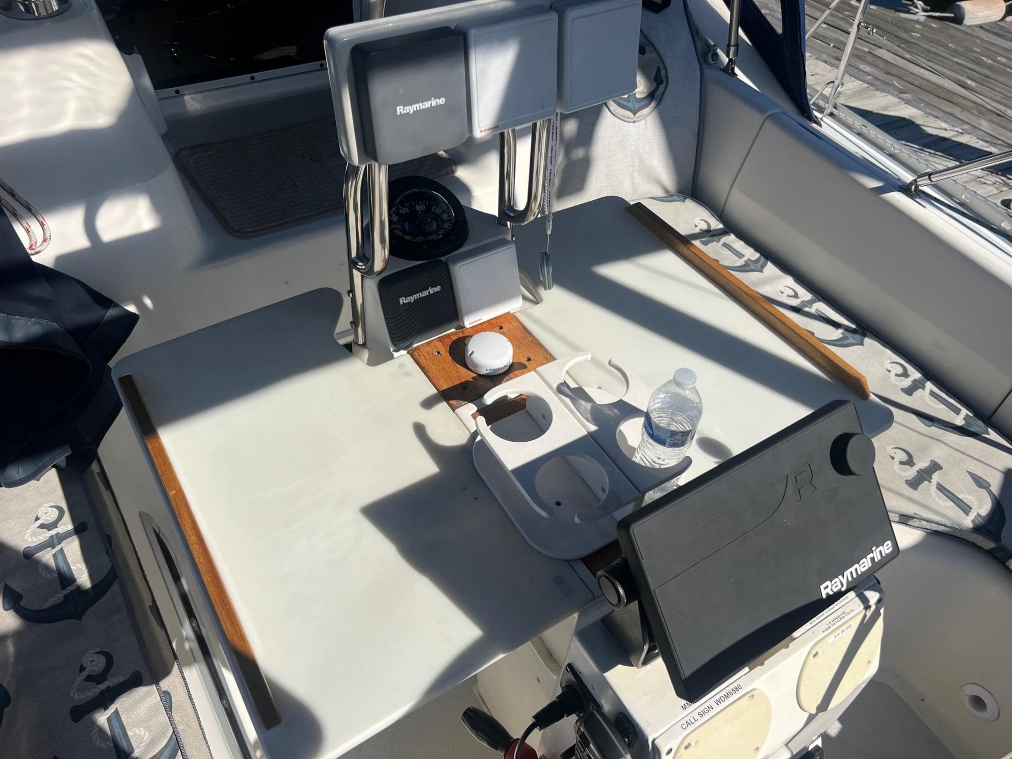 Cockpit of 1992 Hunter 43 sailboat with Raymarine navigation equipment and cup holders.