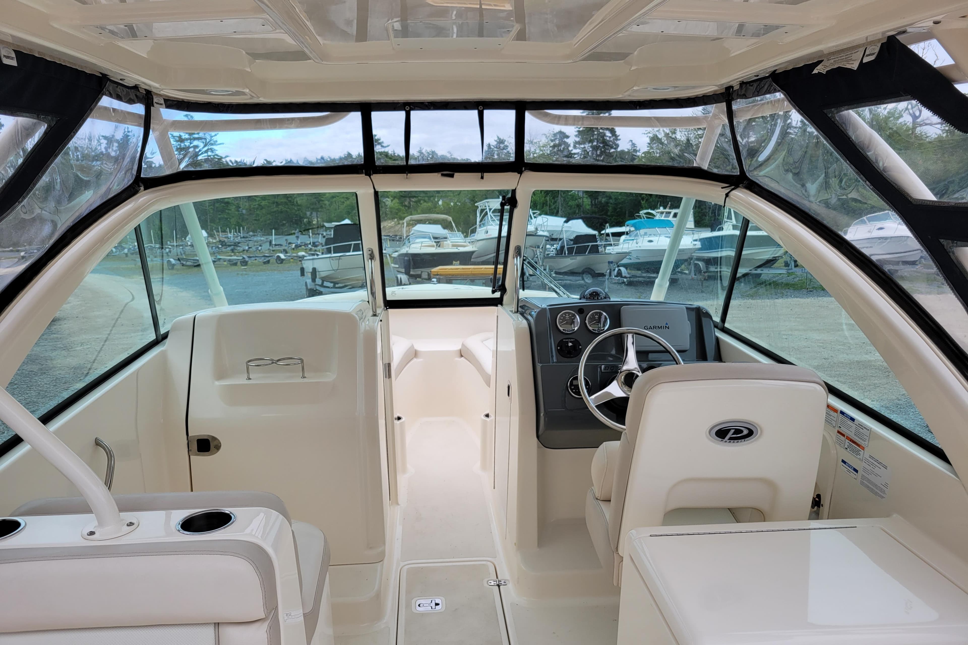 2011 Pursuit DC 265 Dual Console boat interior with steering wheel and seating.