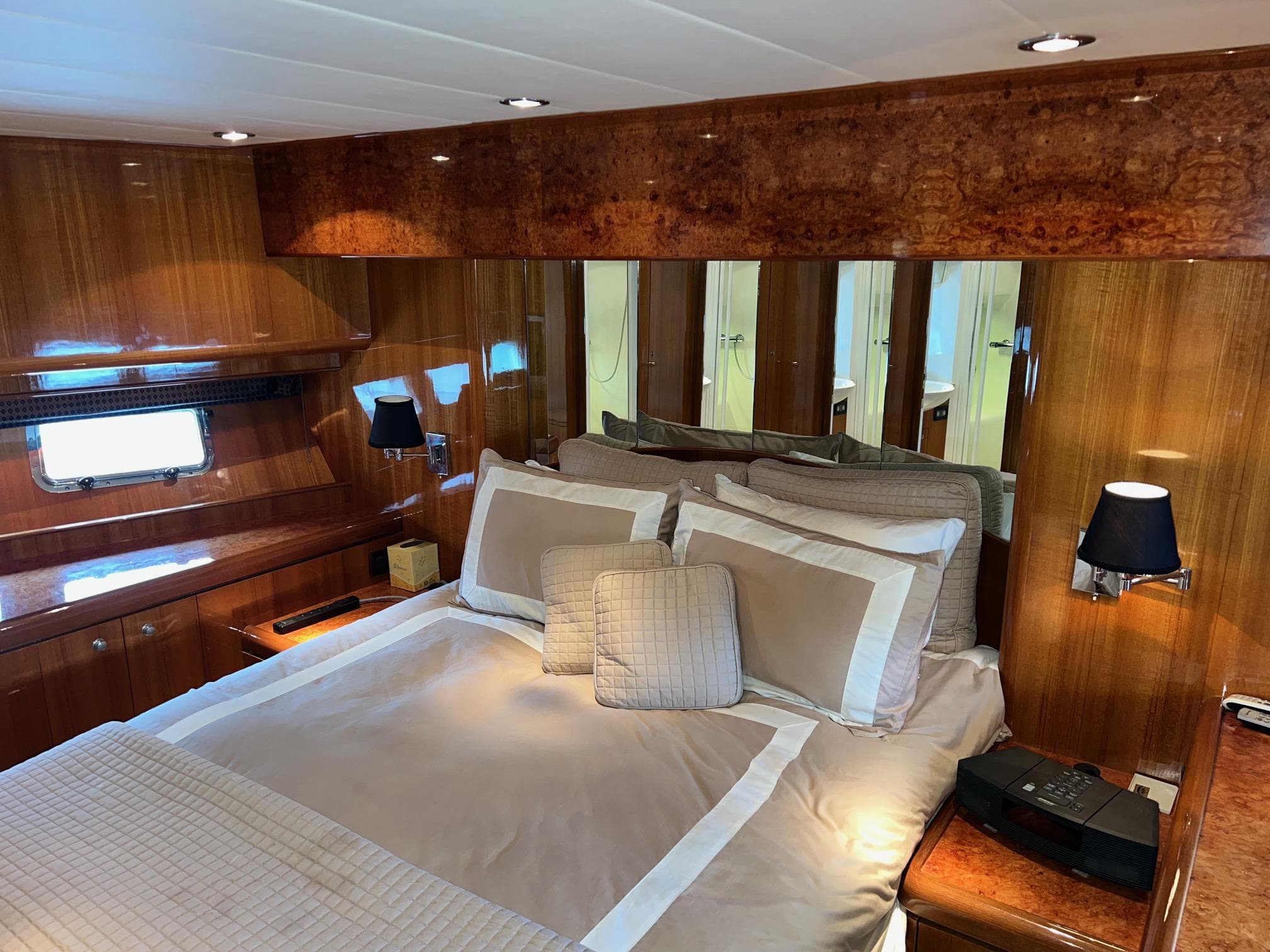 Luxurious bedroom interior of 2001 Horizon Skylounge yacht with elegant wood paneling.