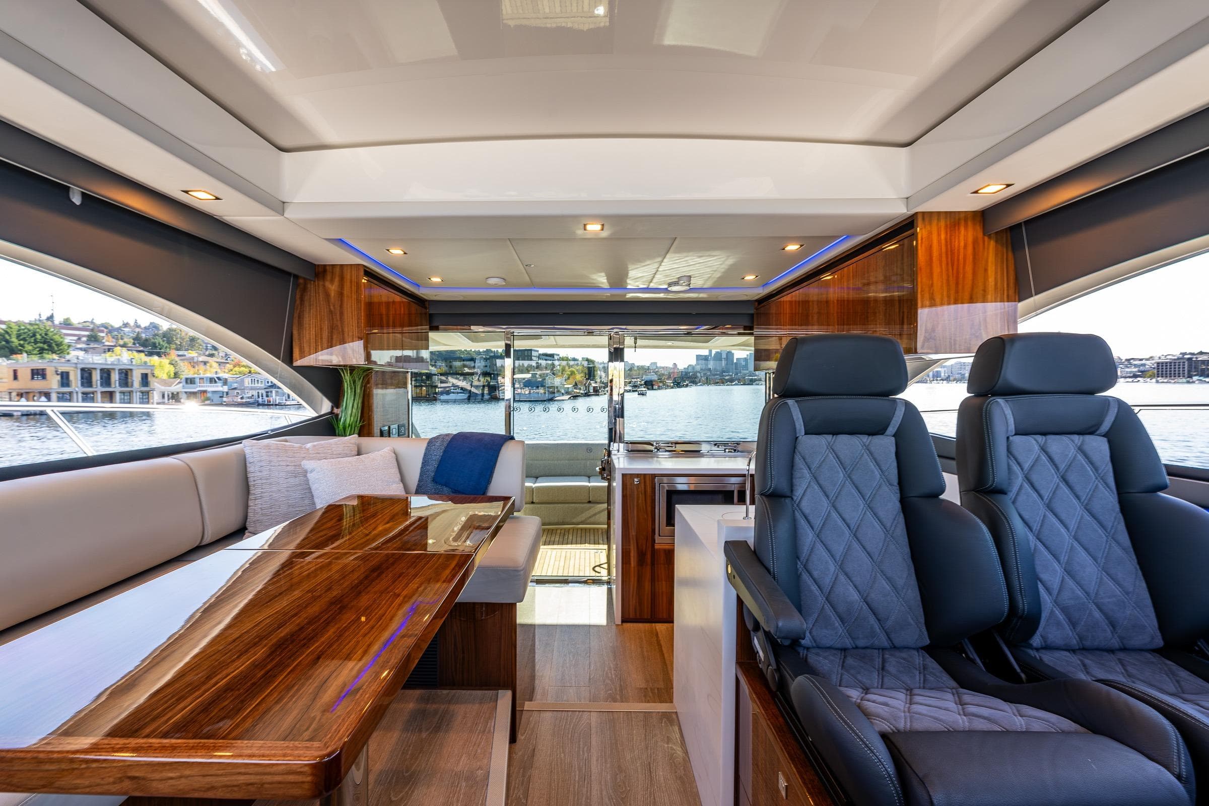 2025 Riviera 4600 Sport Yacht interior with luxurious seating and elegant wood finishes.