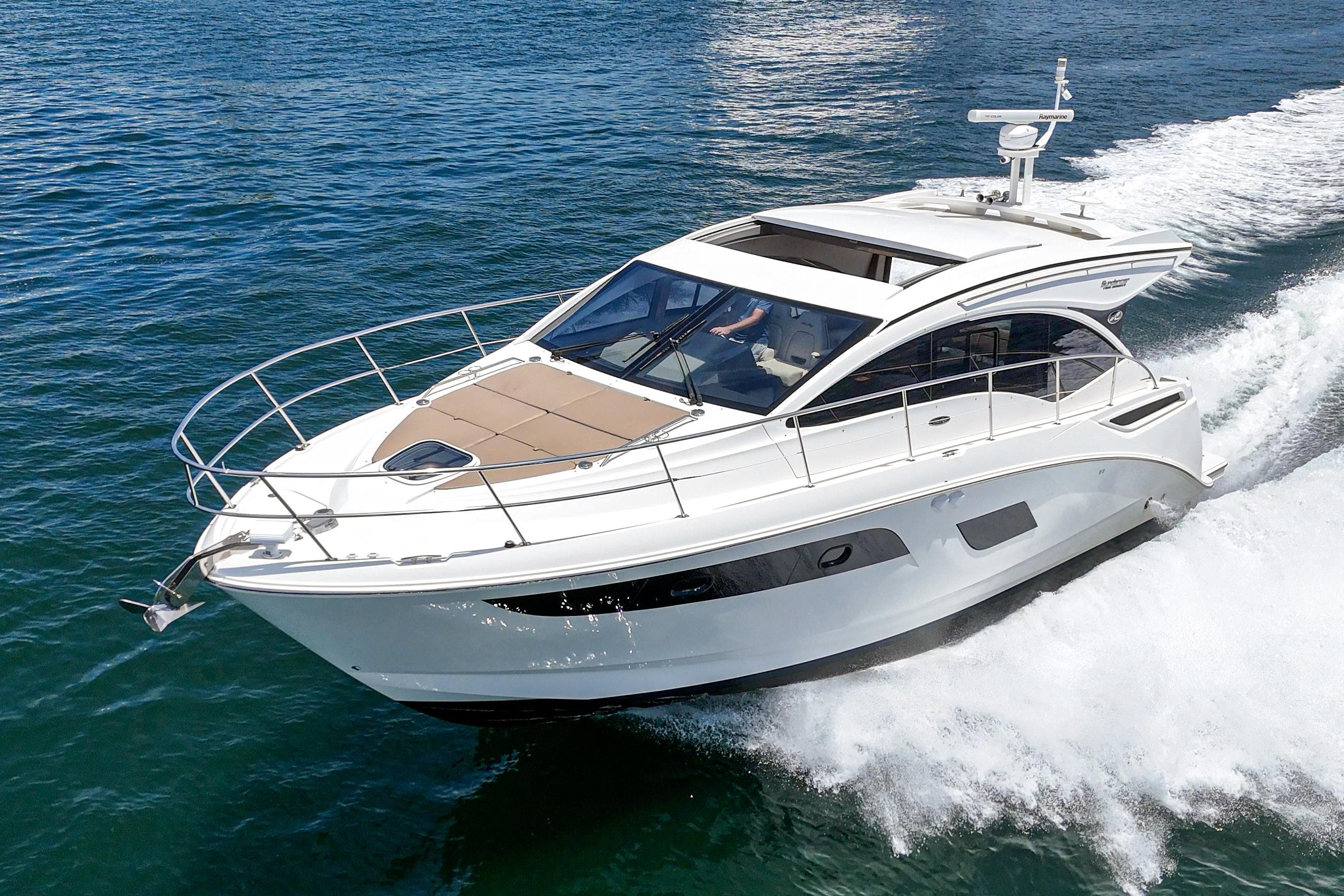 2017 Sea Ray Sundancer 400 cruising on open water, showcasing sleek design and luxury features.