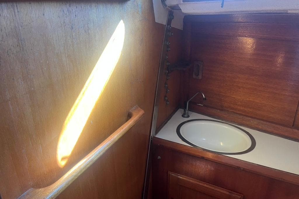 1971 Santana 37 yacht interior with wooden cabinetry and sink.