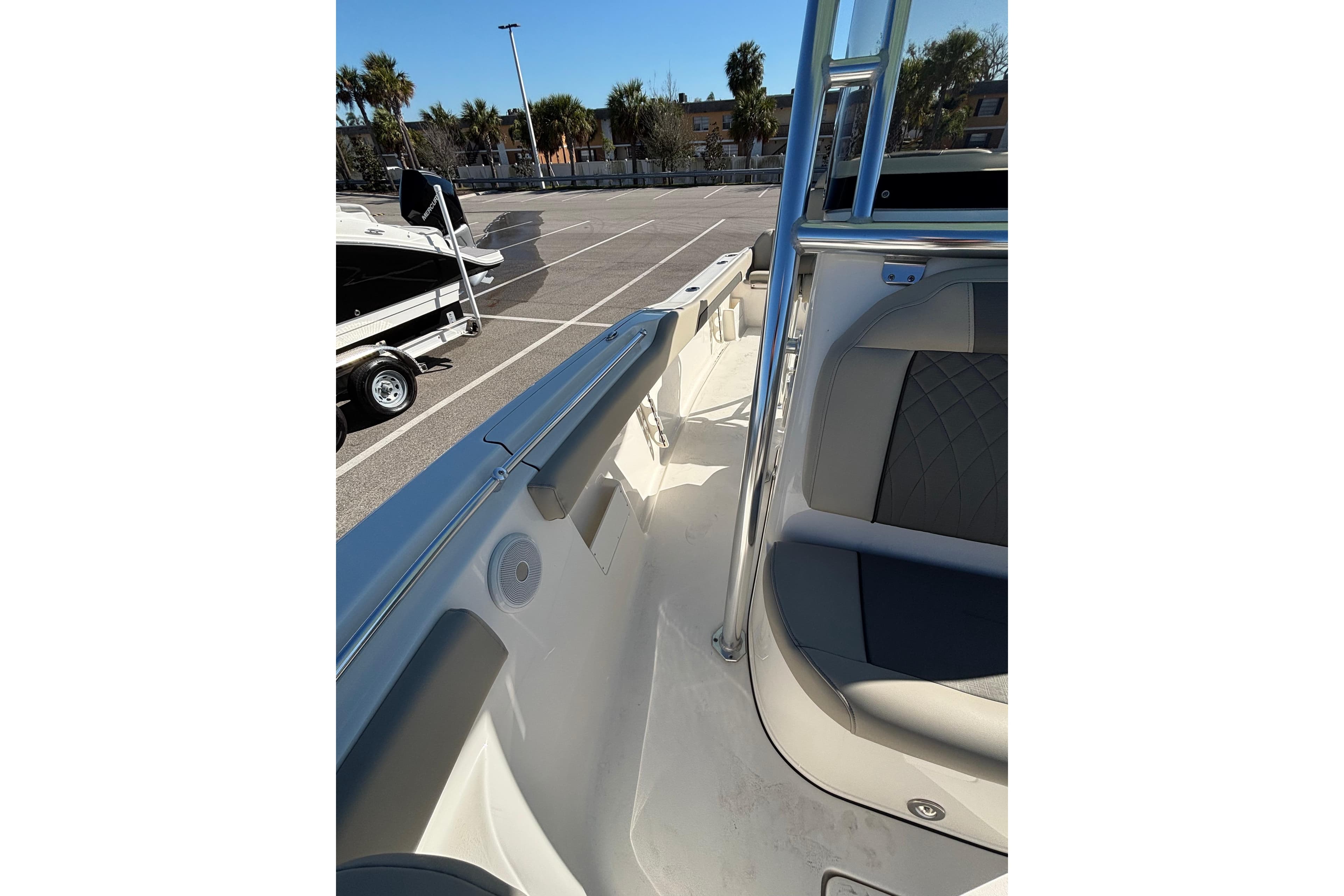 2025 Key West 239 FS boat interior with seating and railing in a parking lot.