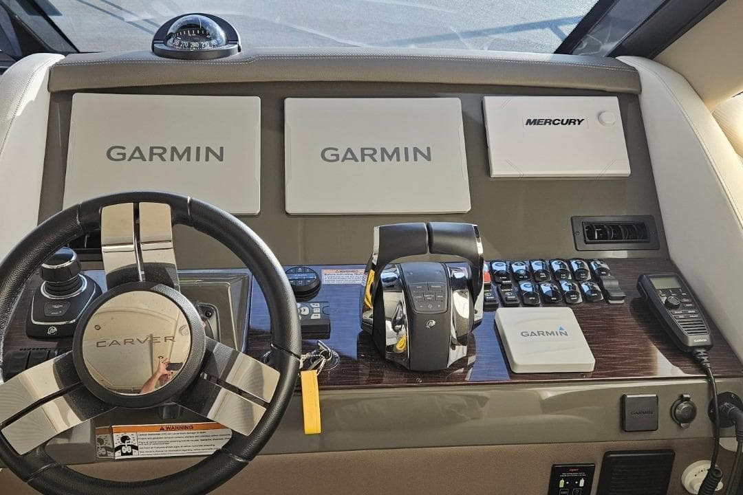 Helm of 2020 Carver C37 Coupe featuring Garmin navigation and Mercury controls.