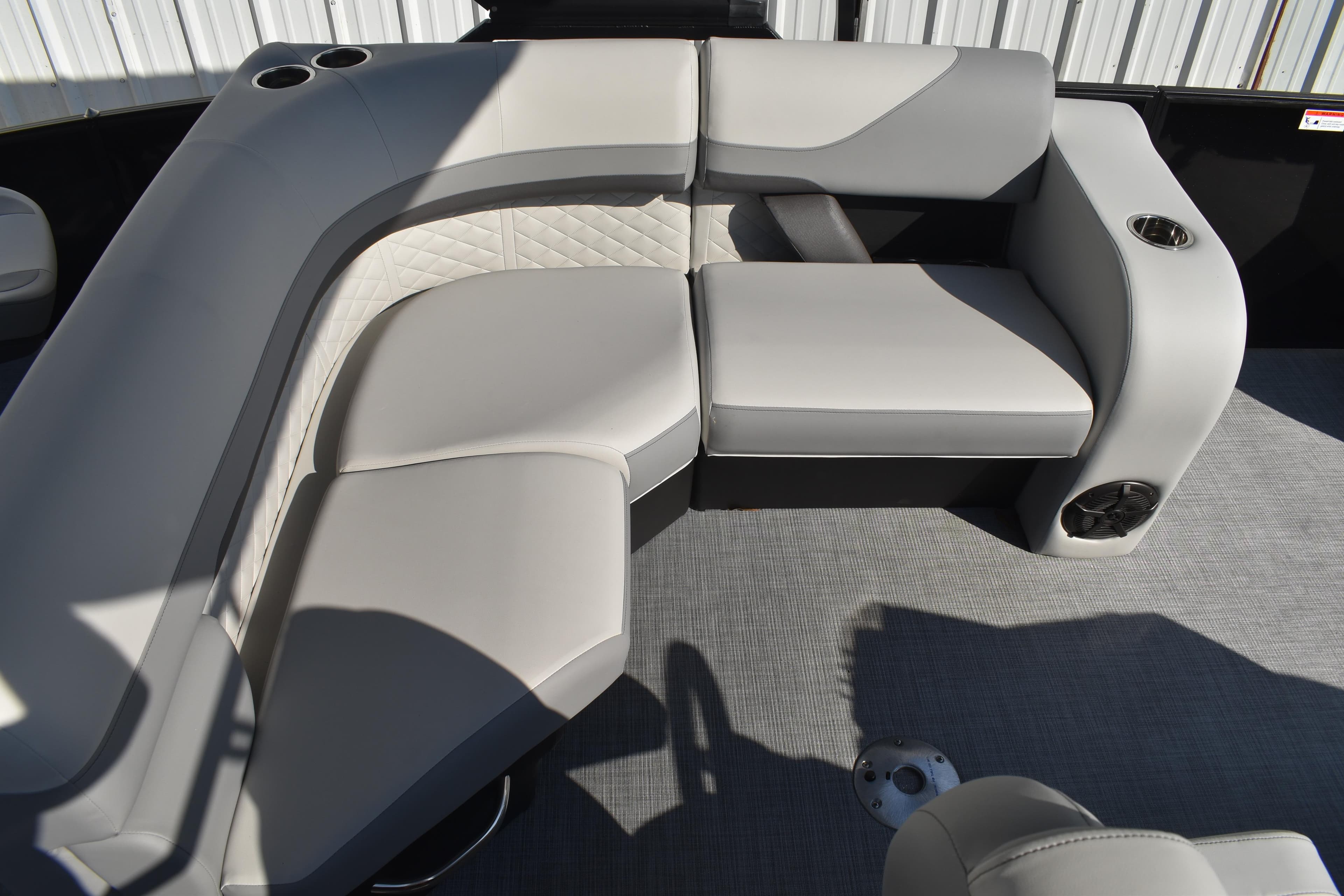 2026 Lowe SF 232 Sport Fish boat interior with gray cushioned seating and cup holders.