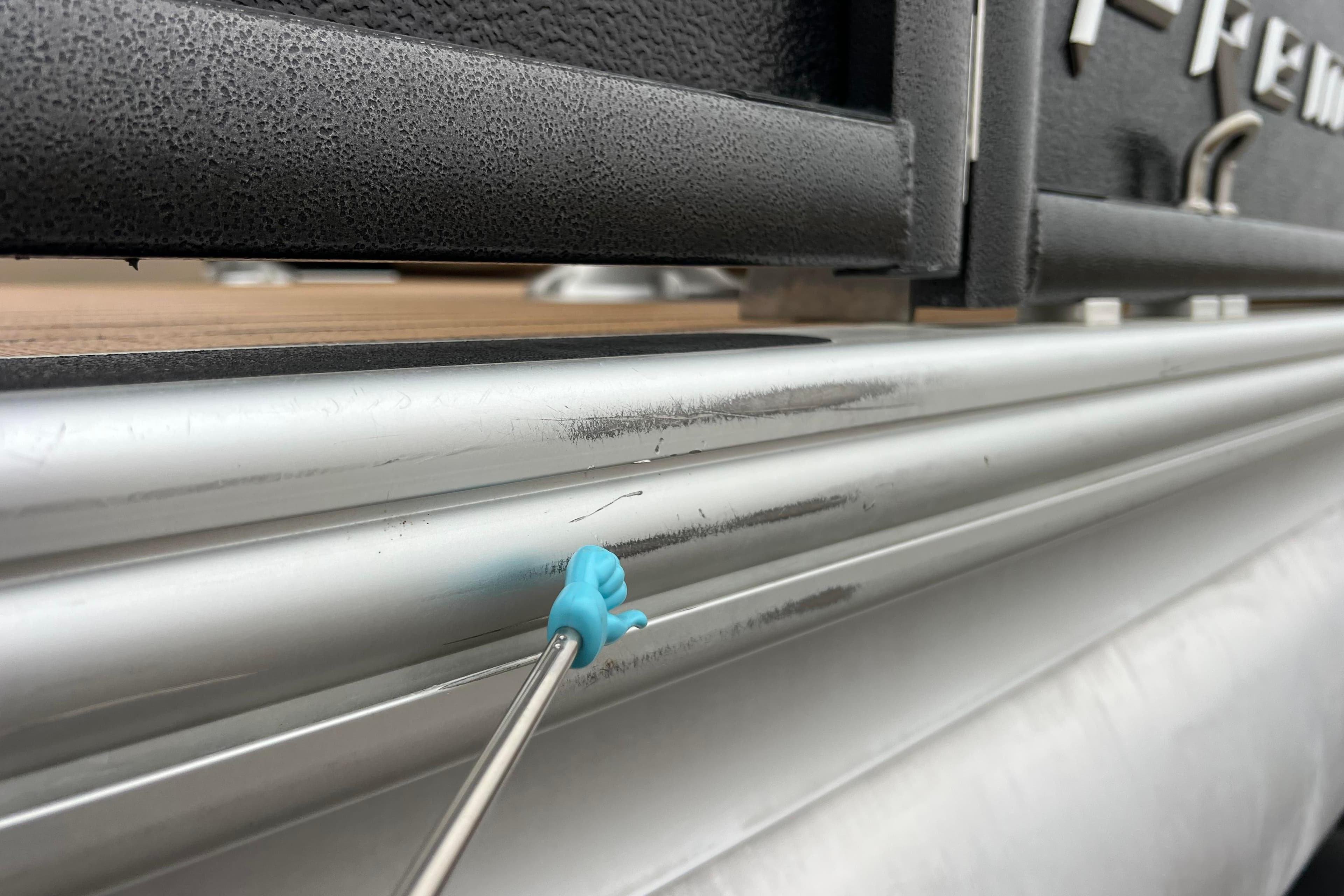 Close-up of 2017 Premier 230 SunSation RF boat with minor surface scratches.