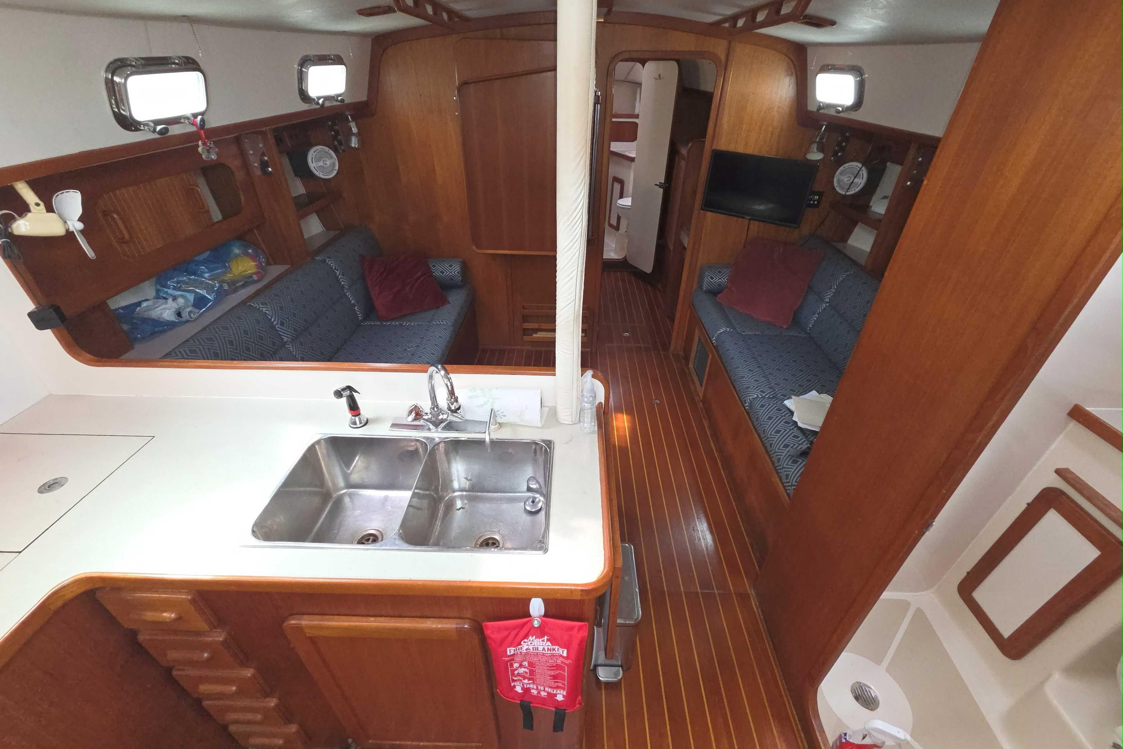 Interior of 2001 Caliber 40LRC yacht with wooden finish and cozy seating area.