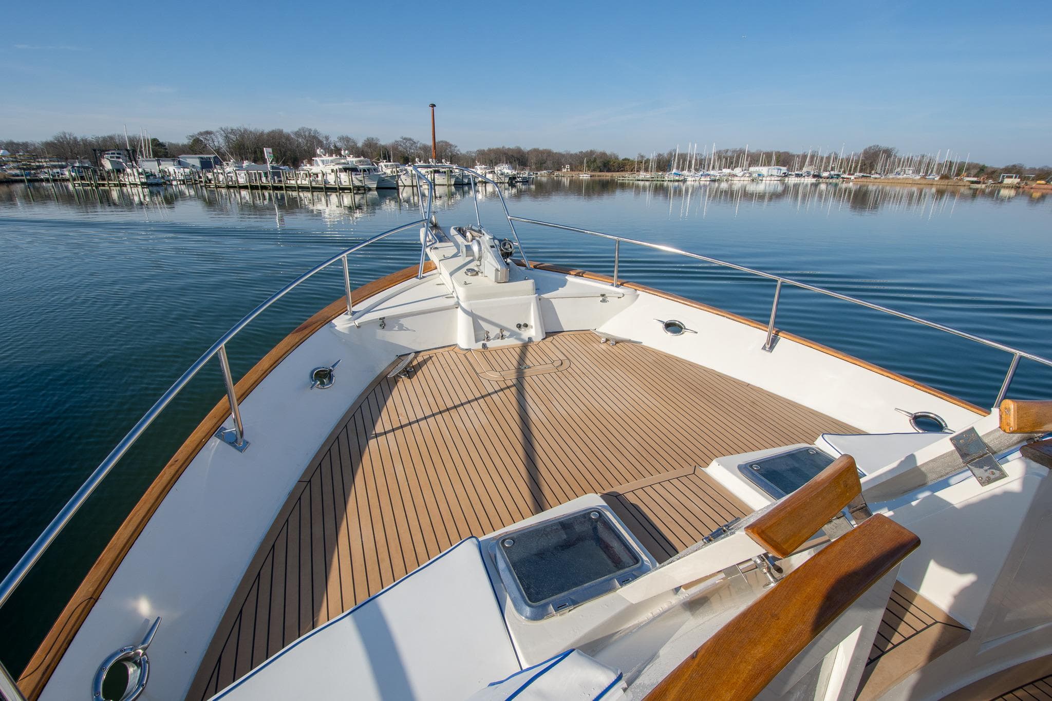 Bow view of 2000 Fleming 55 yacht on calm water near marina.