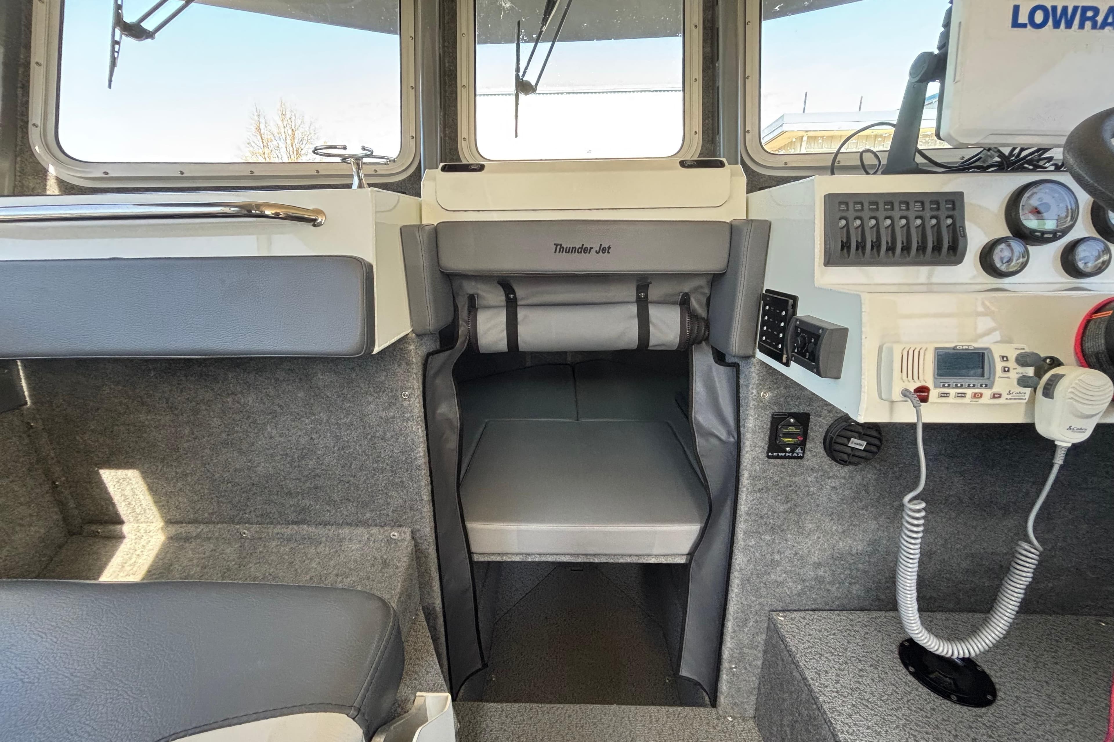 Interior of a 2021 Thunder Jet 28 Pilot boat with control panel and seating.