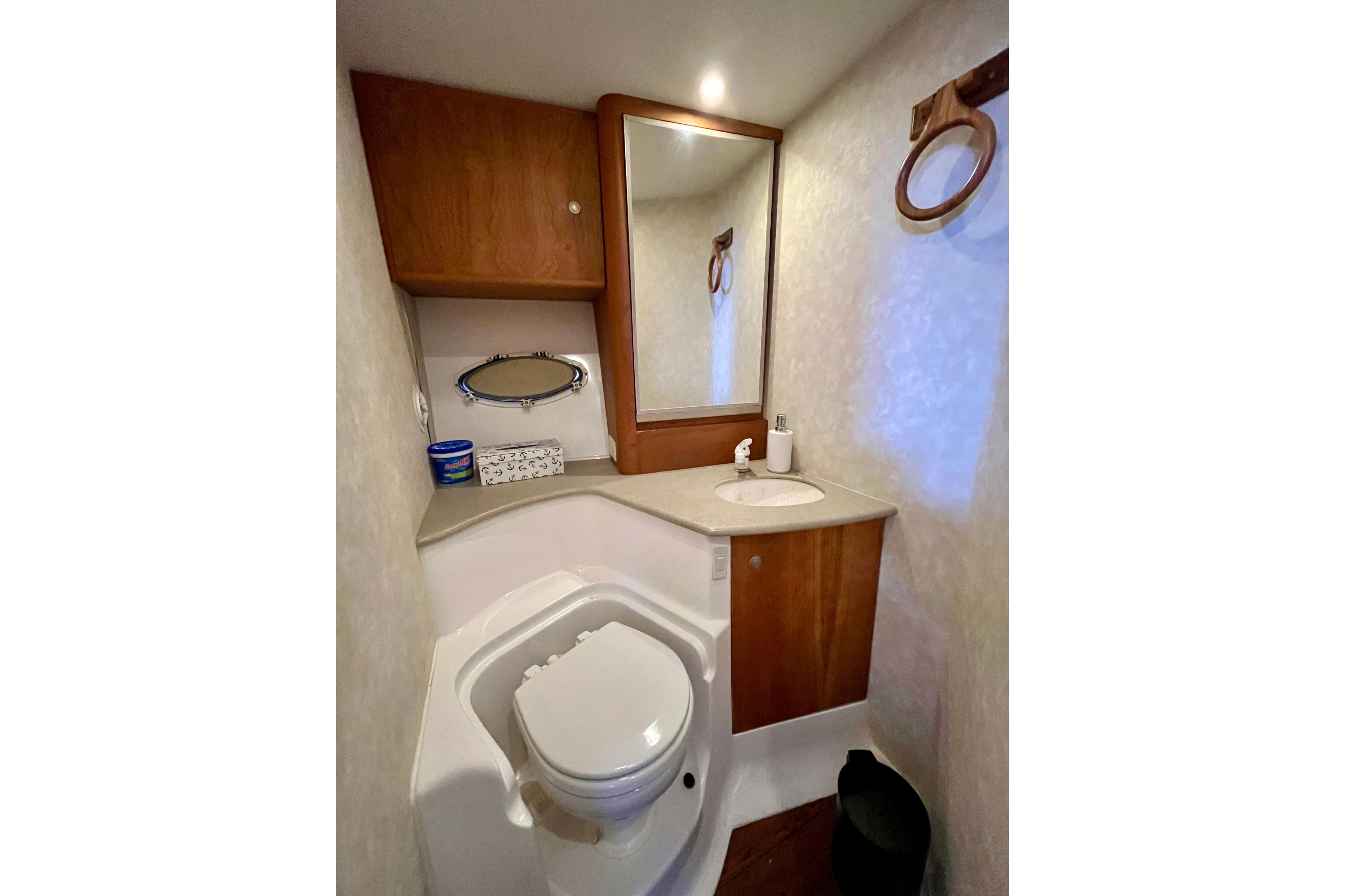 Bathroom interior of 1997 Silverton 362 Sedan Cruiser with toilet, sink, and mirror.