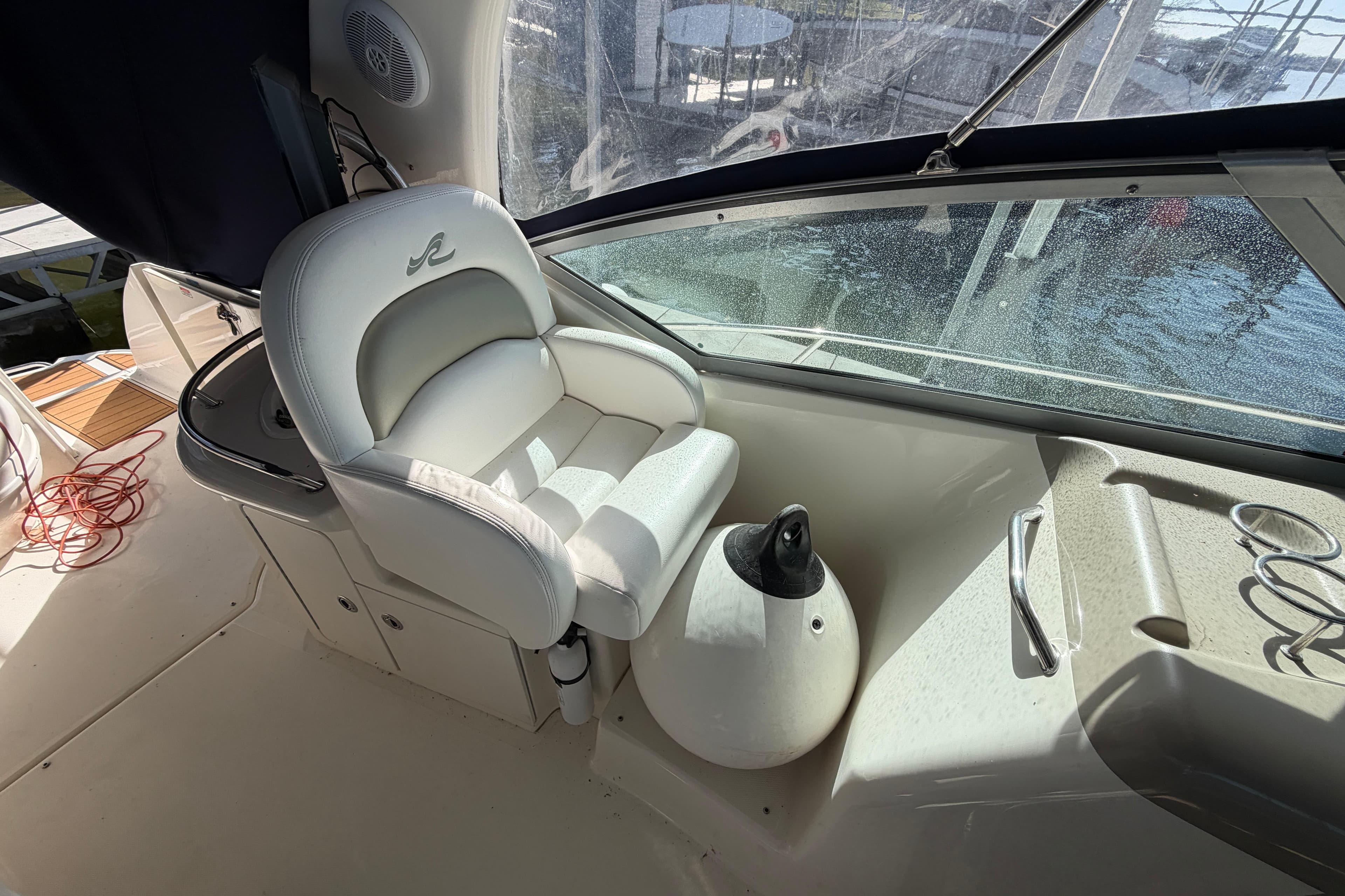 Captain's seat on 2006 Sea Ray 340 Sundancer boat, with helm and window view.