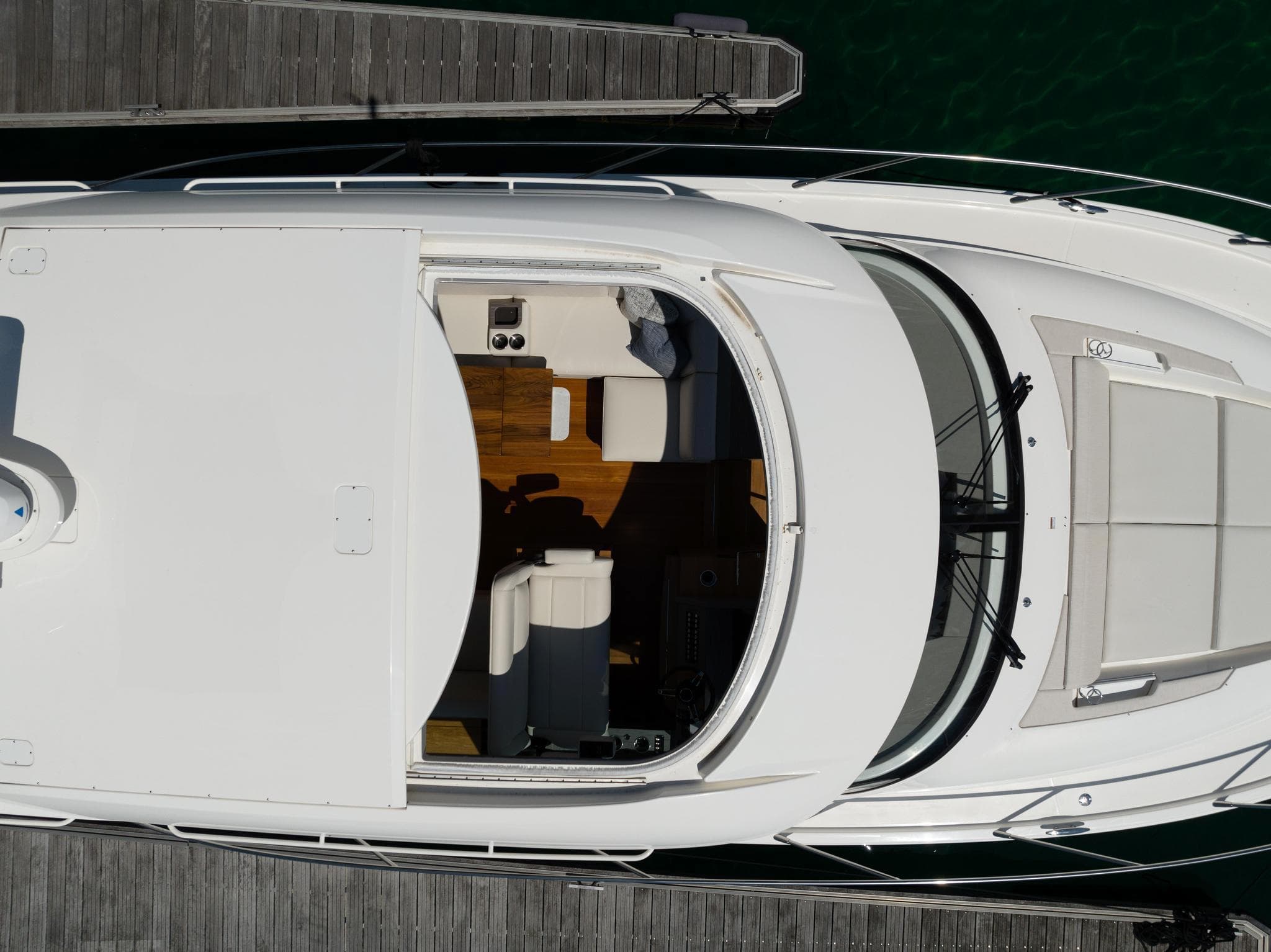 Overhead view of 2022 Tiara Yachts C49 Coupe docked, showcasing sleek design and spacious interior.
