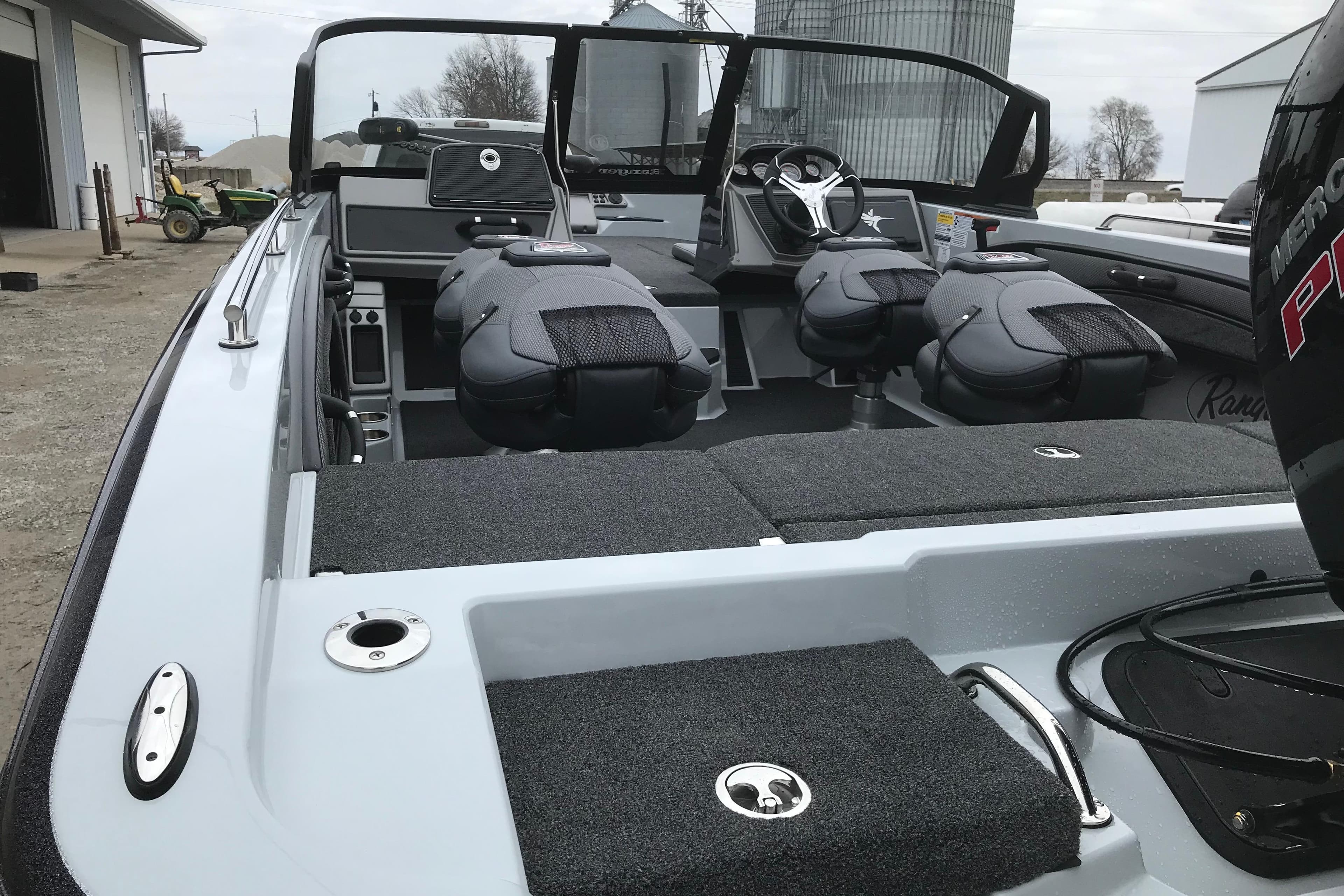 2026 Ranger 1880MS boat interior with seating and steering wheel, parked outdoors.