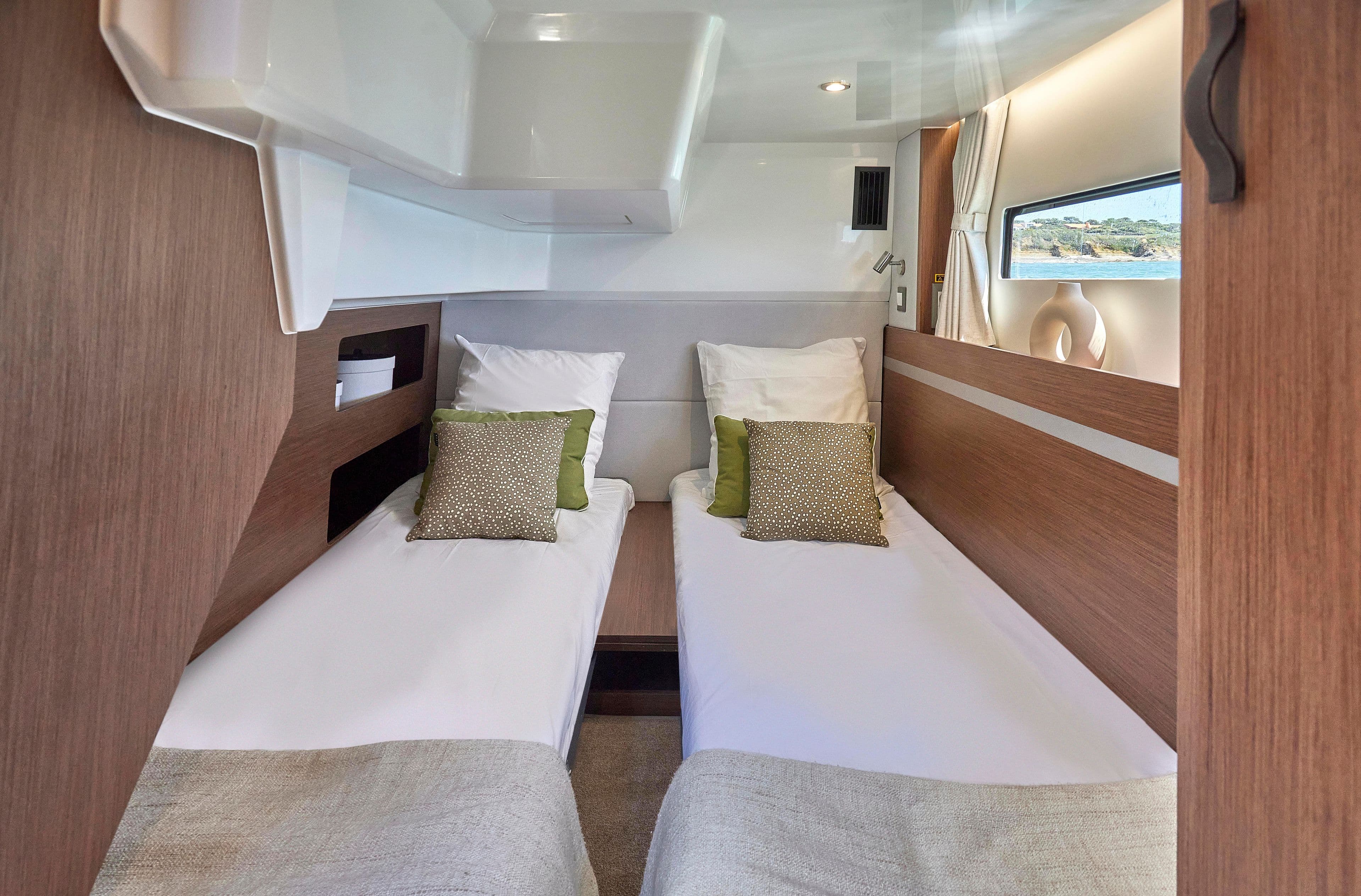2026 Beneteau Antares 12 cabin interior with twin beds and modern decor.