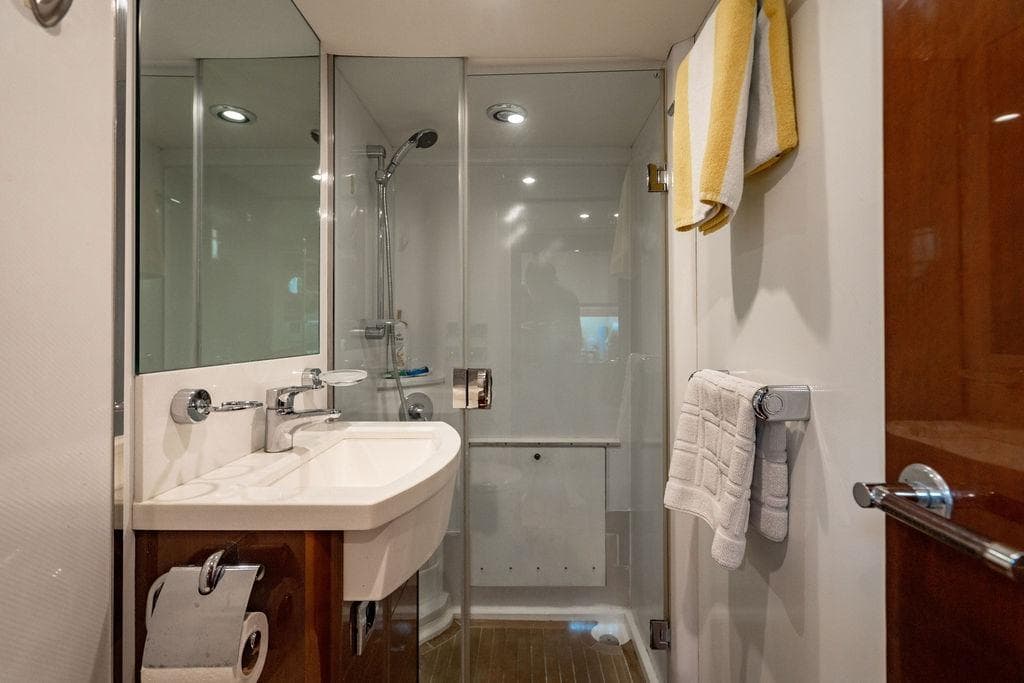 Bathroom interior of 2010 Princess 95 Motor Yacht with shower and sink.