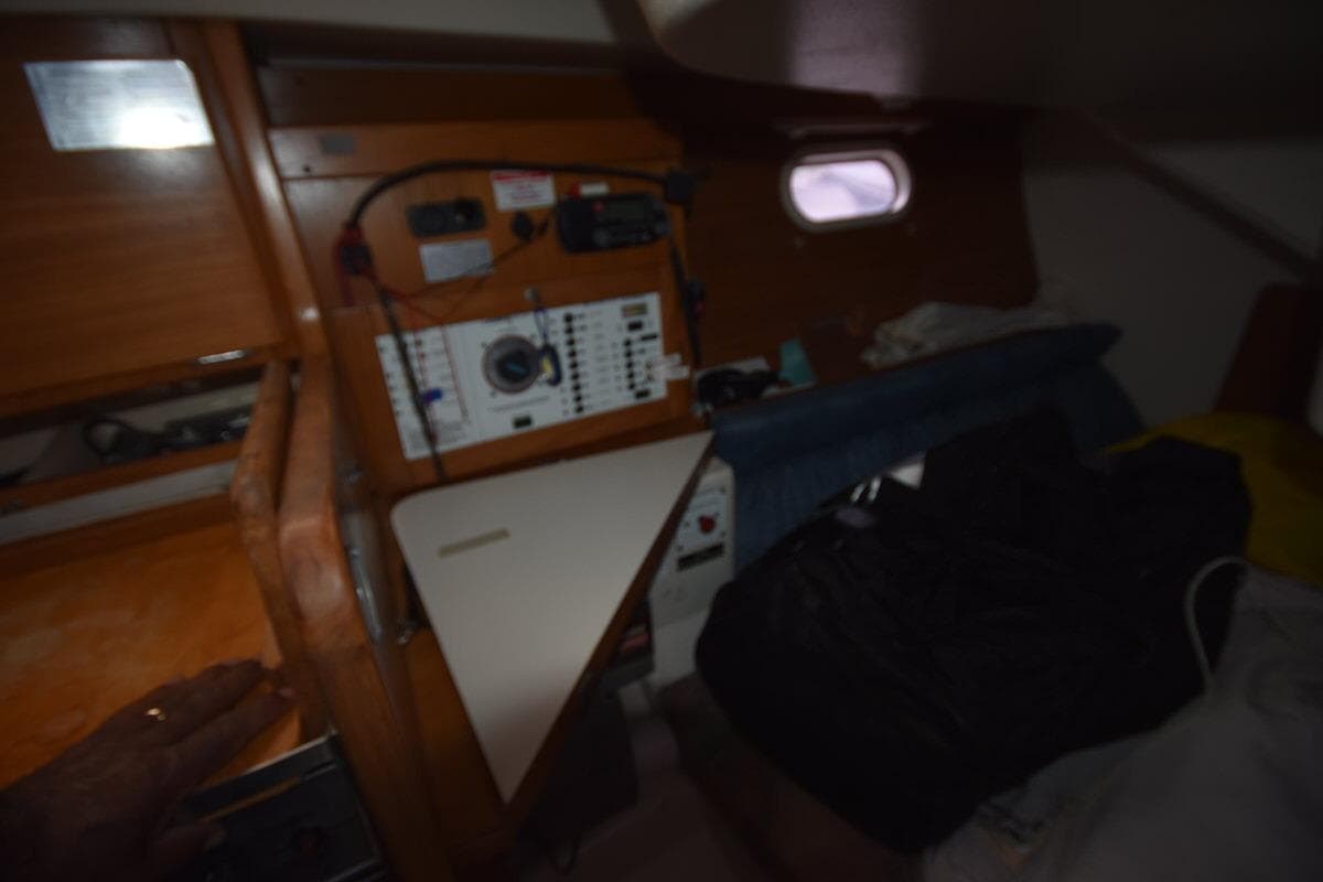 Interior of a 2001 Catalina 310 sailboat with navigation equipment and wooden cabinetry.
