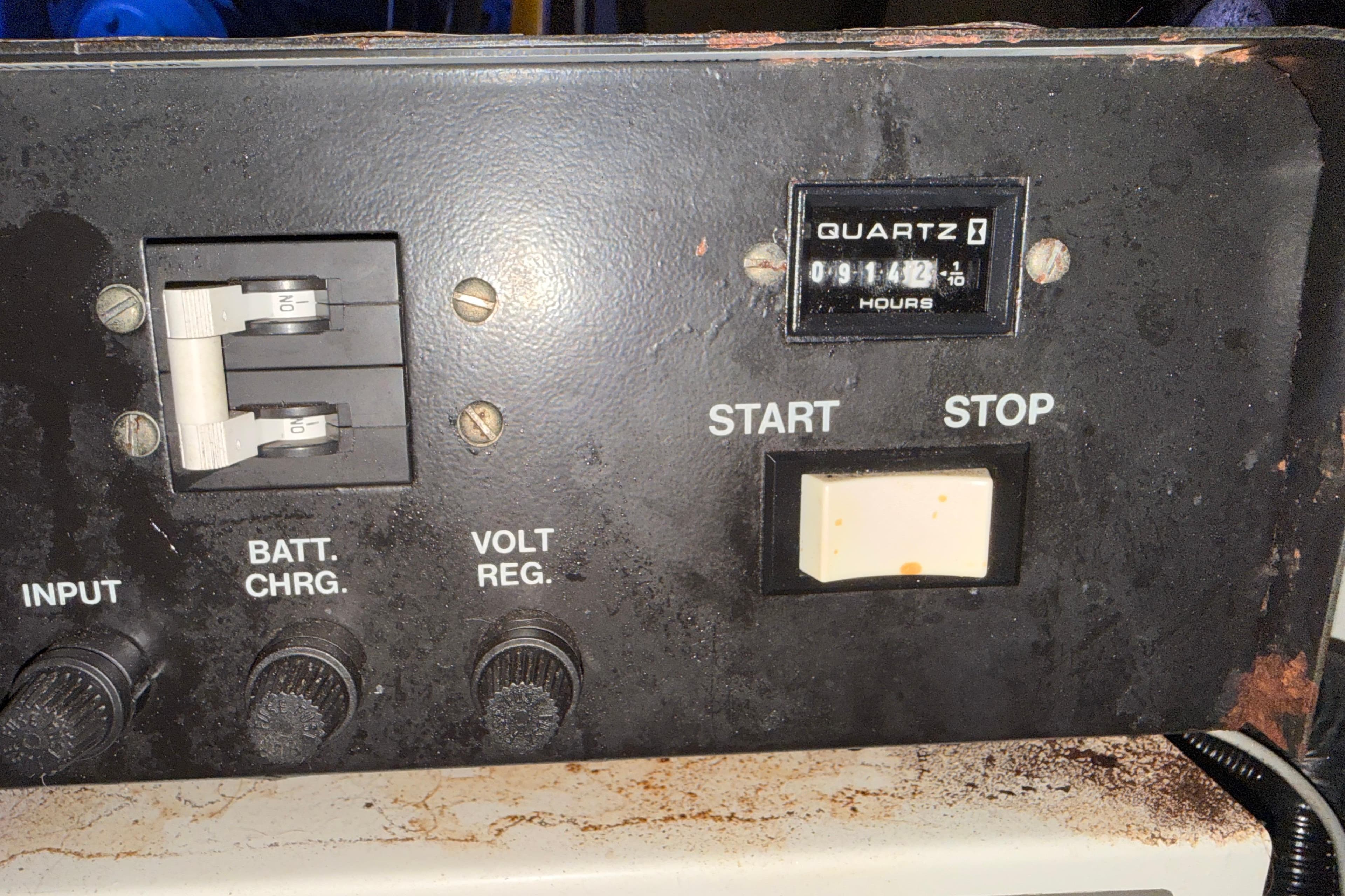 Control panel of a 1998 Silverton 40 Convertible boat with hour meter and switches.