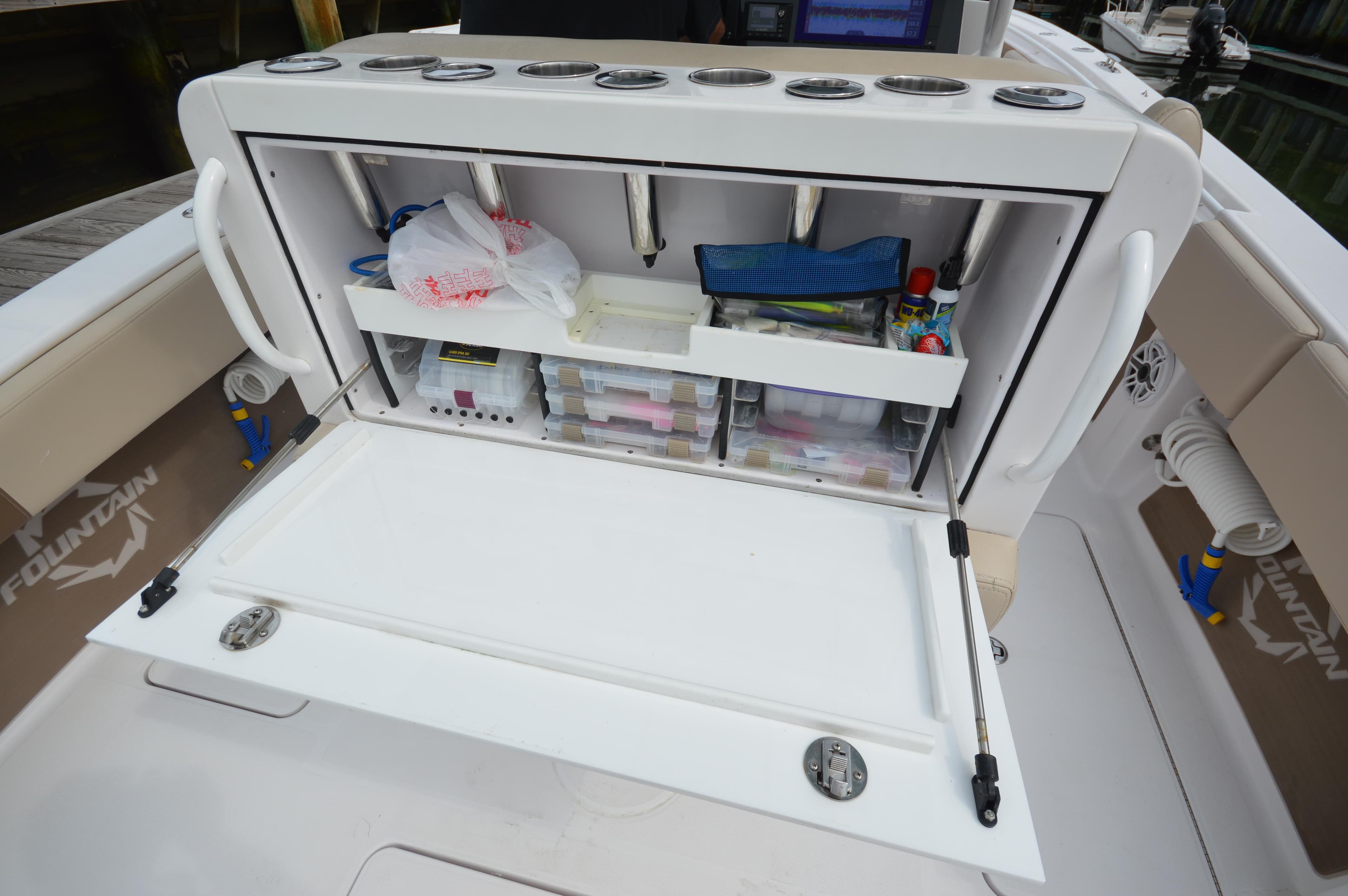 2017 Fountain 38 Center Console boat with open storage compartment.