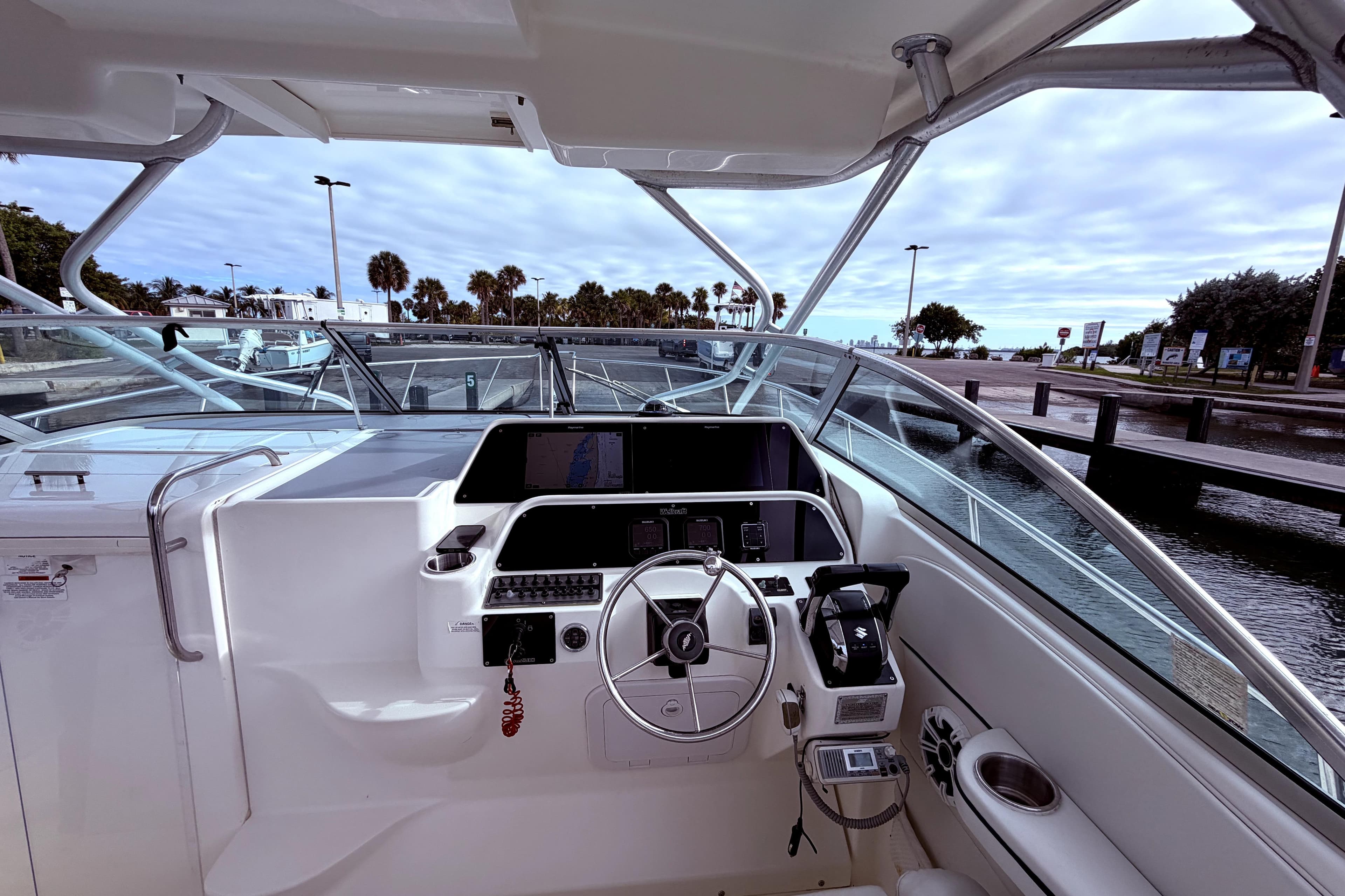 2001 Wellcraft 290 Coastal boat cockpit with steering wheel and navigation controls.