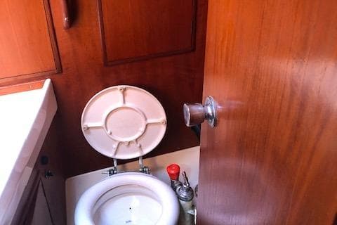 Interior of 1981 Nautor Swan 371 Sloop showing compact marine toilet.