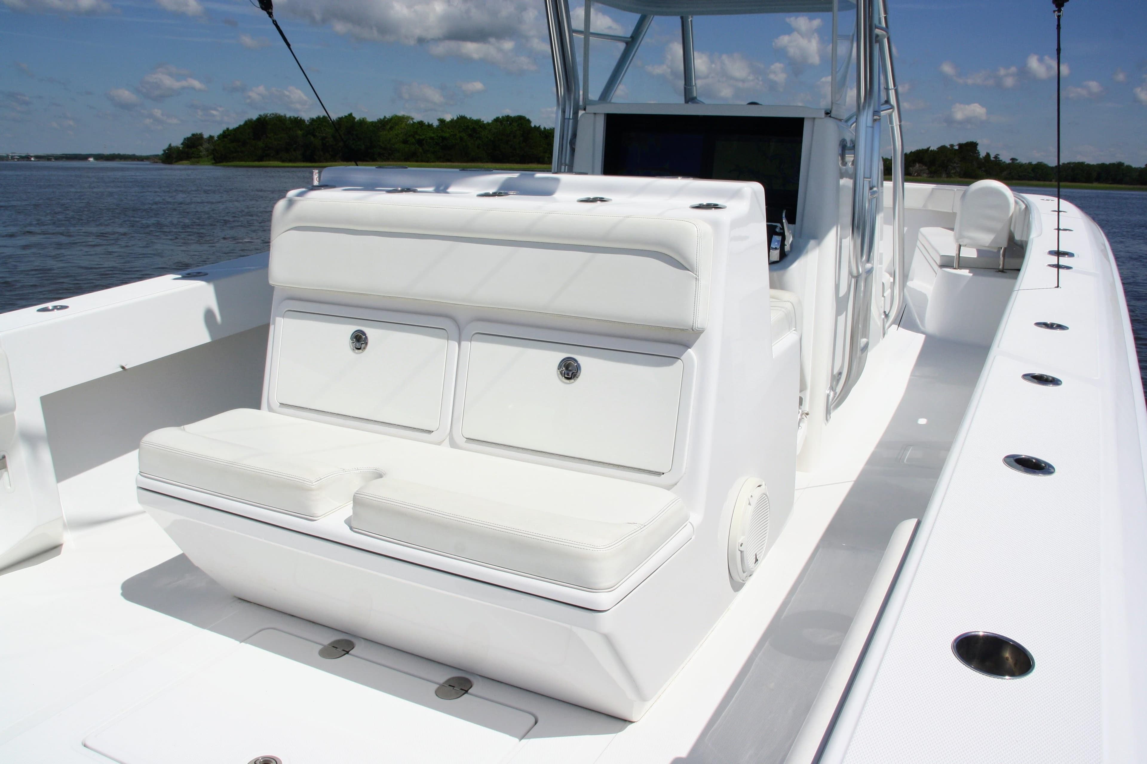 2019 Bahama 41 boat with white seating, sleek design, and spacious deck on a sunny day.