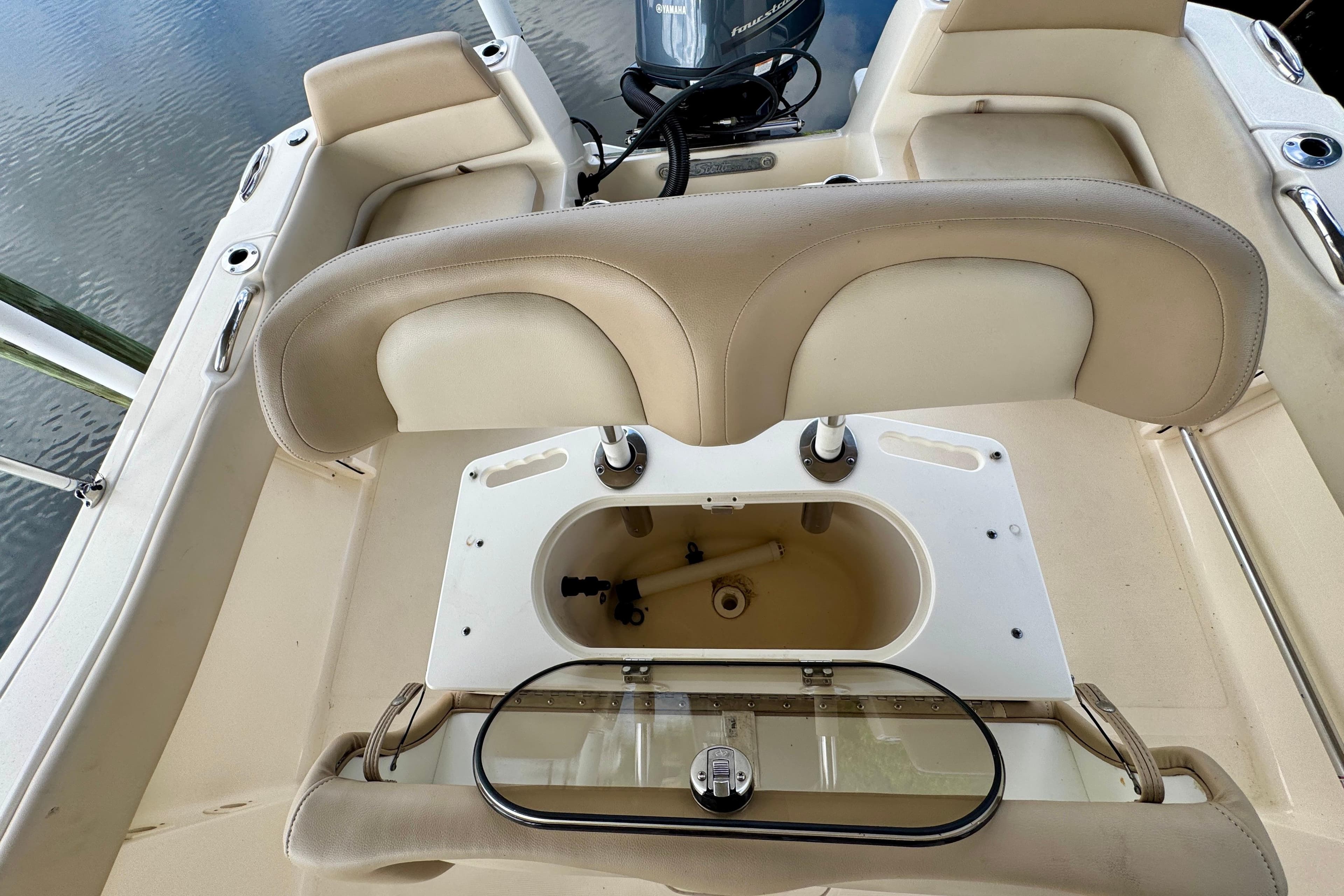 2024 Scout 195 Sportfish boat interior with seating and storage compartment.
