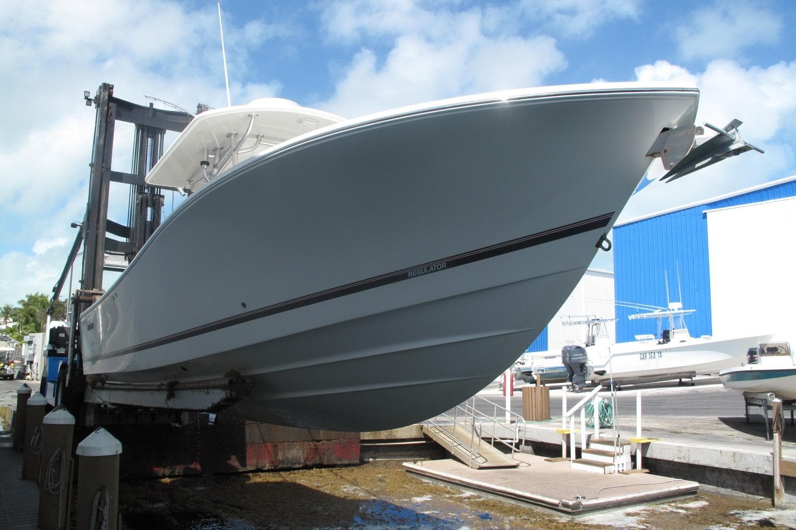 2013 Regulator 32 Forward Seating boat on lift at marina.