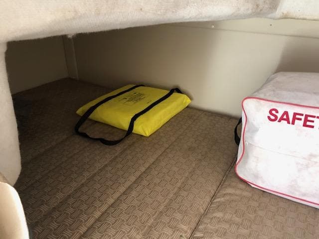 2007 Monterey 250 Cruiser cabin with safety equipment and yellow life jacket.