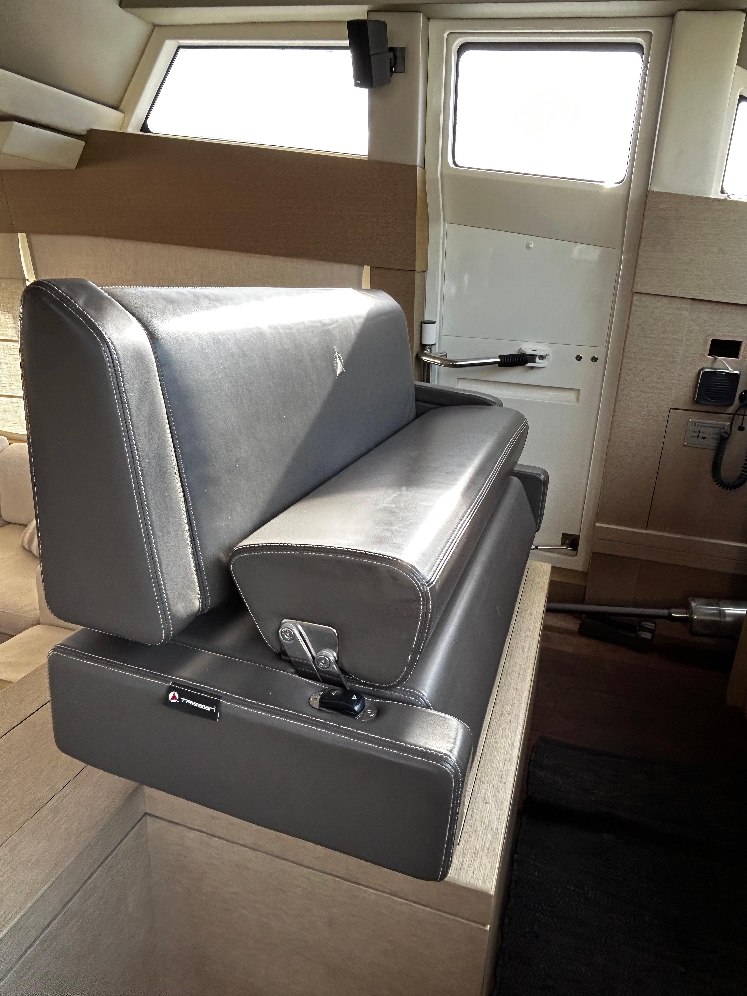 Luxury seating inside a 2015 Prestige 750 yacht, featuring sleek leather upholstery.