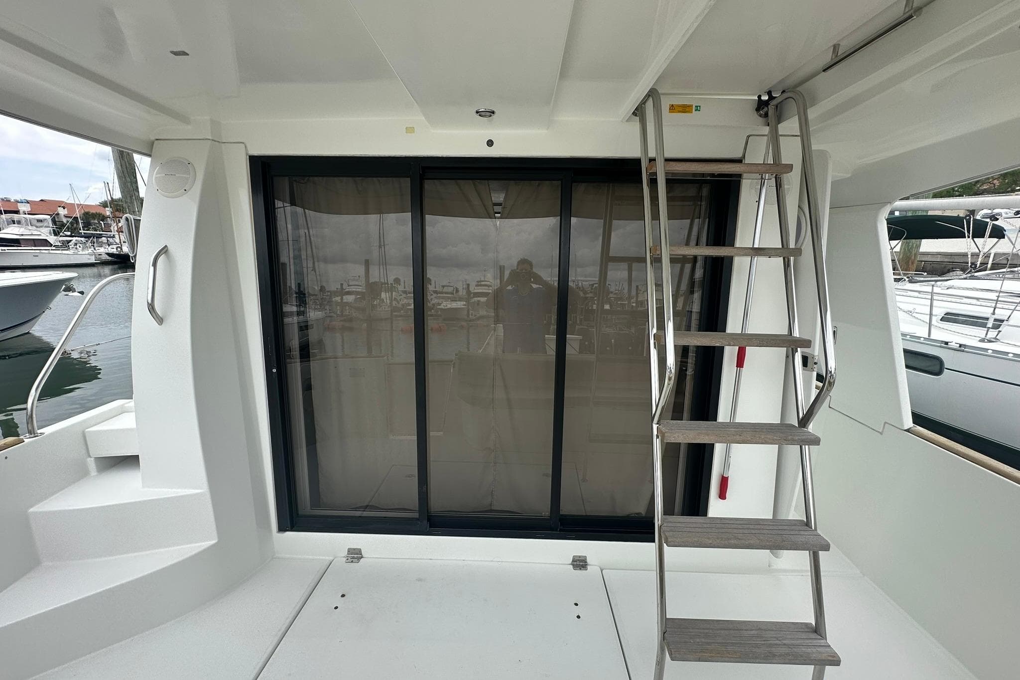 2011 Beneteau Swift Trawler 34 Fly, rear deck with sliding glass doors and ladder.